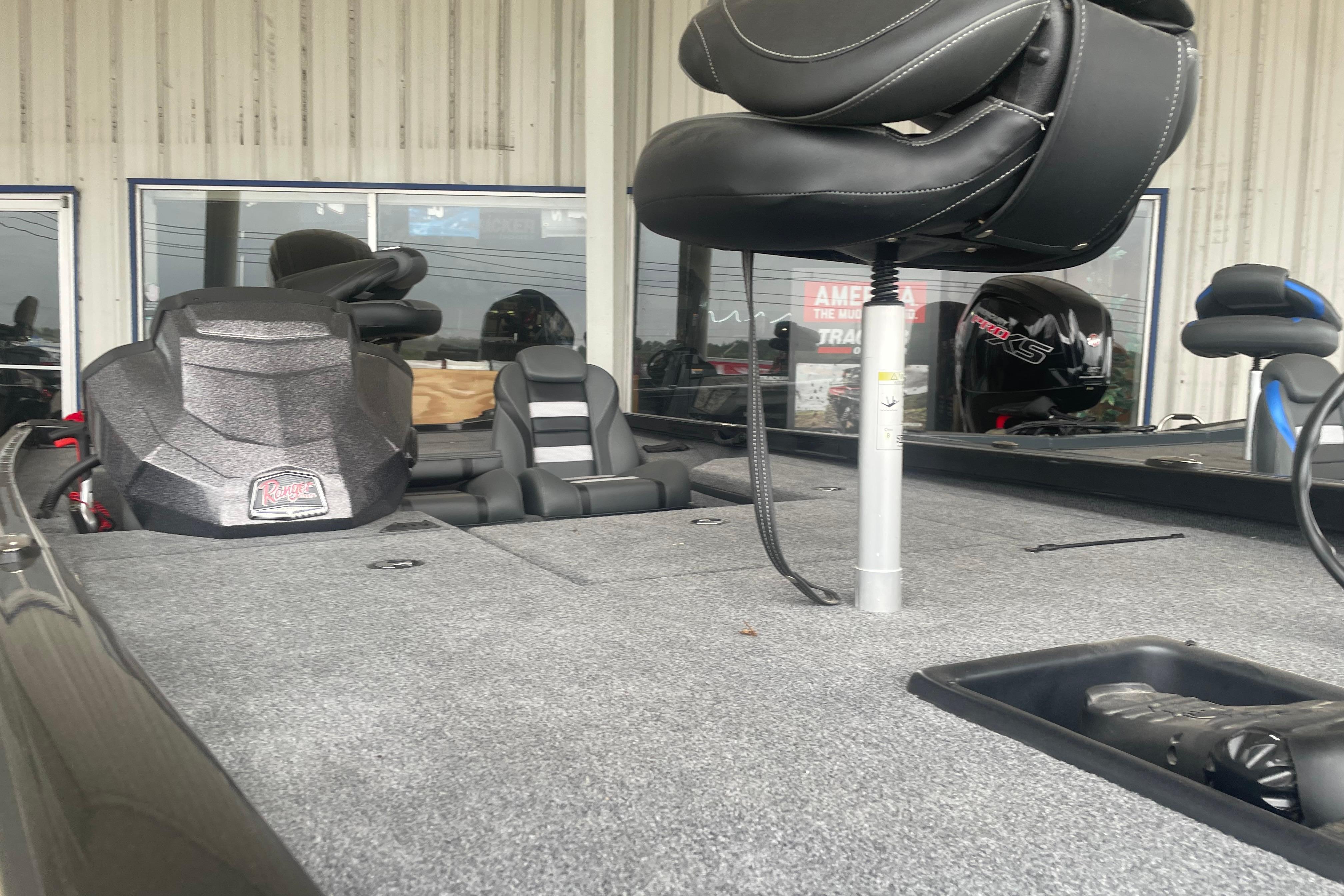 2026 Ranger RT178 boat interior with seating and equipment, displayed in a showroom.