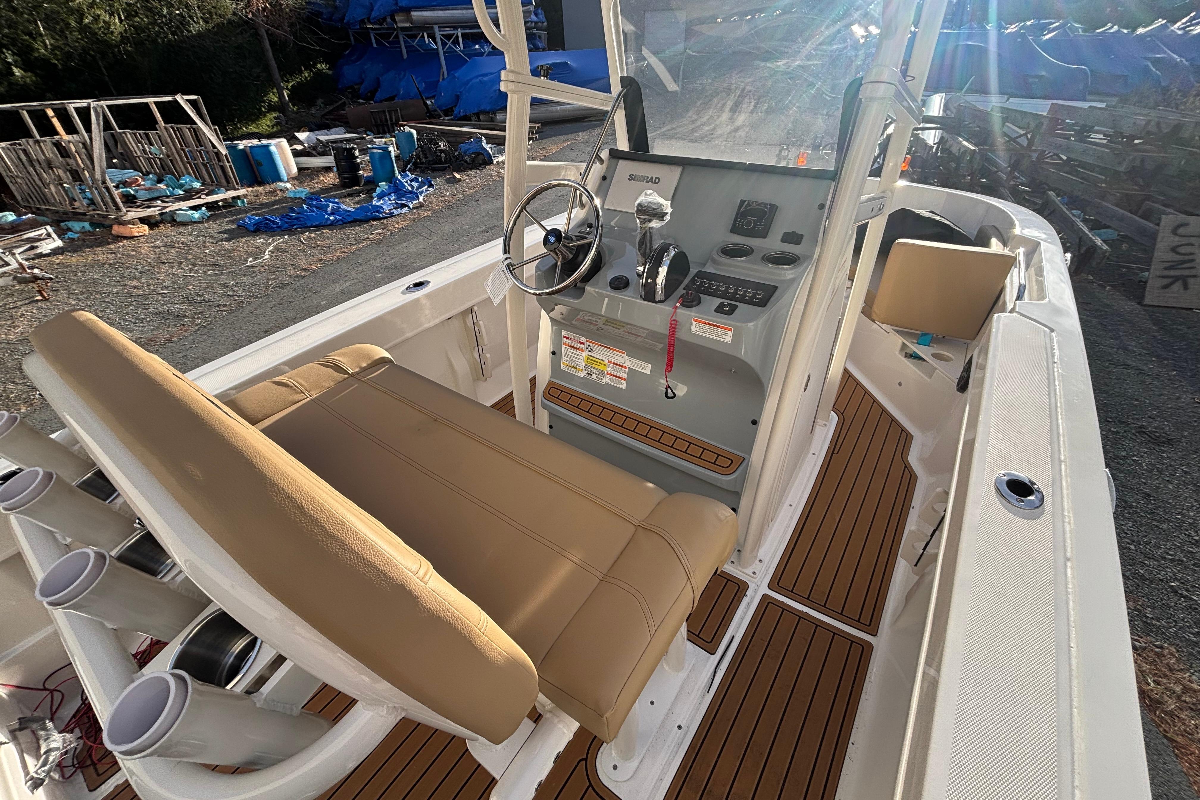 2026 Bayliner Trophy T20CC boat interior with helm, seating, and rod holders.