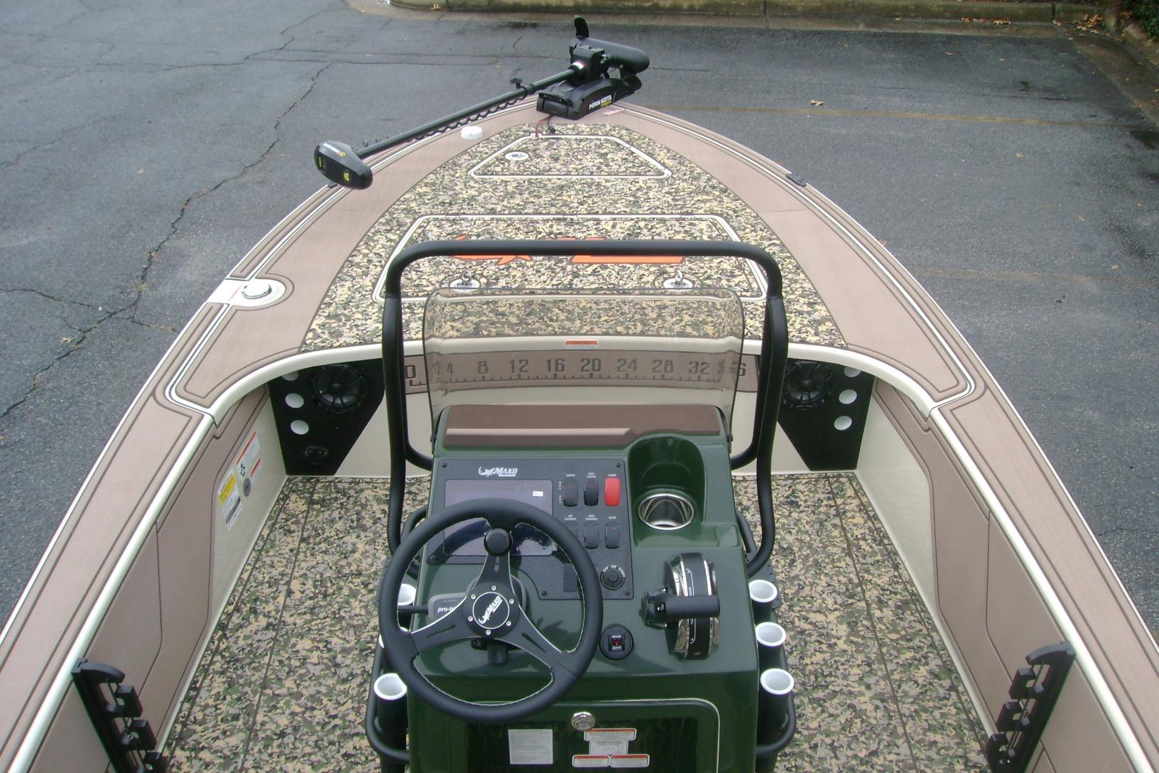 2025 Mako 18 Pro Skiff Backwater Edition boat interior with steering console and camo design.
