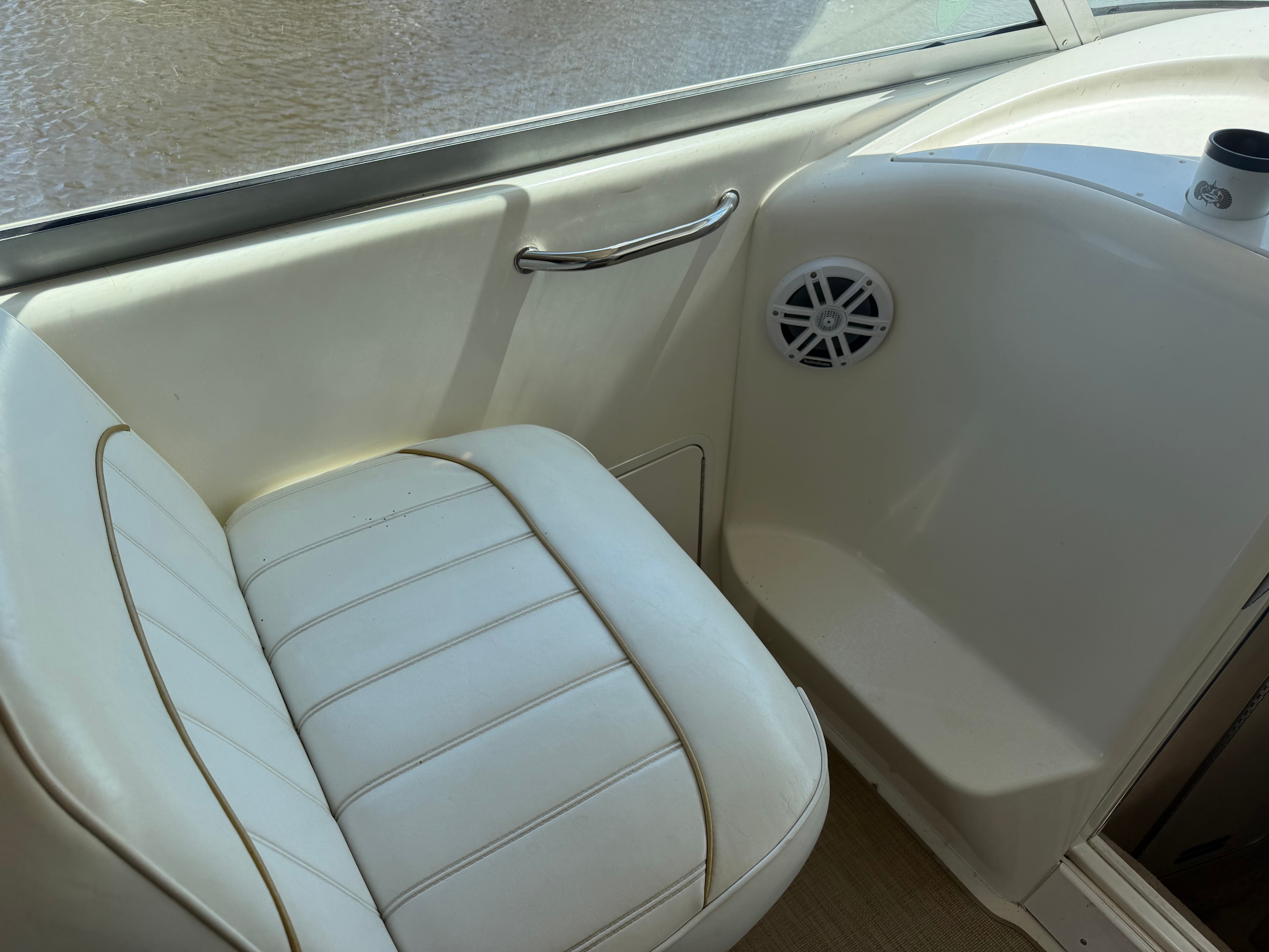 Interior of a 1996 Sea Ray Sundancer 330 boat with seat and speaker.
