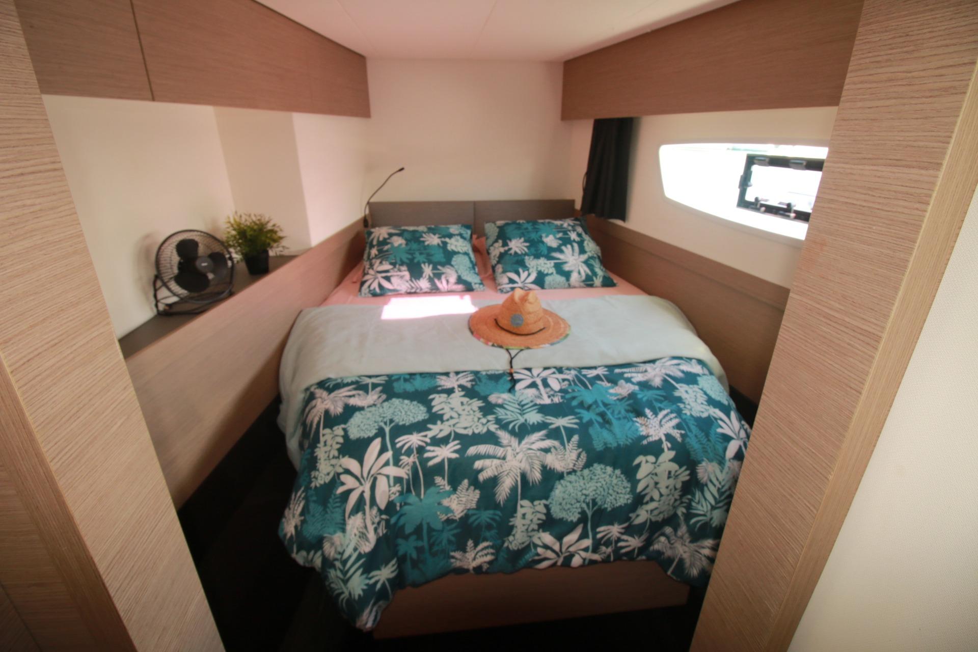 2022 Fountaine Pajot Elba 45 Catamaran bedroom with tropical bedding and window view.