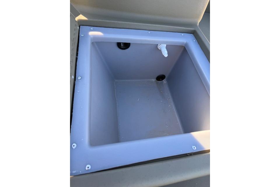 Open storage compartment in 2026 Tracker Grizzly 1648 SC boat.