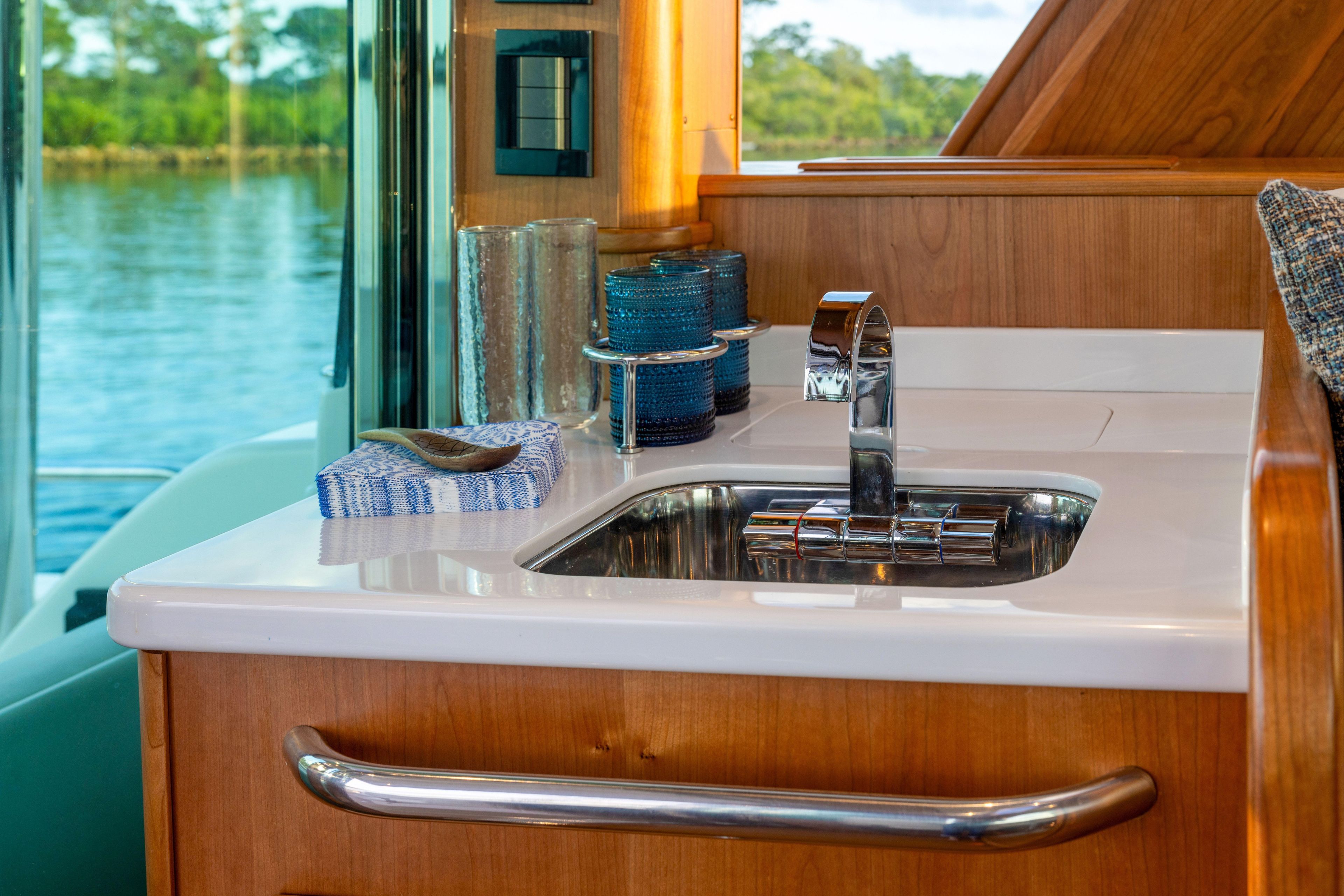 Luxurious interior of 2027 Sabre 51 Salon Express yacht with modern sink and scenic view.