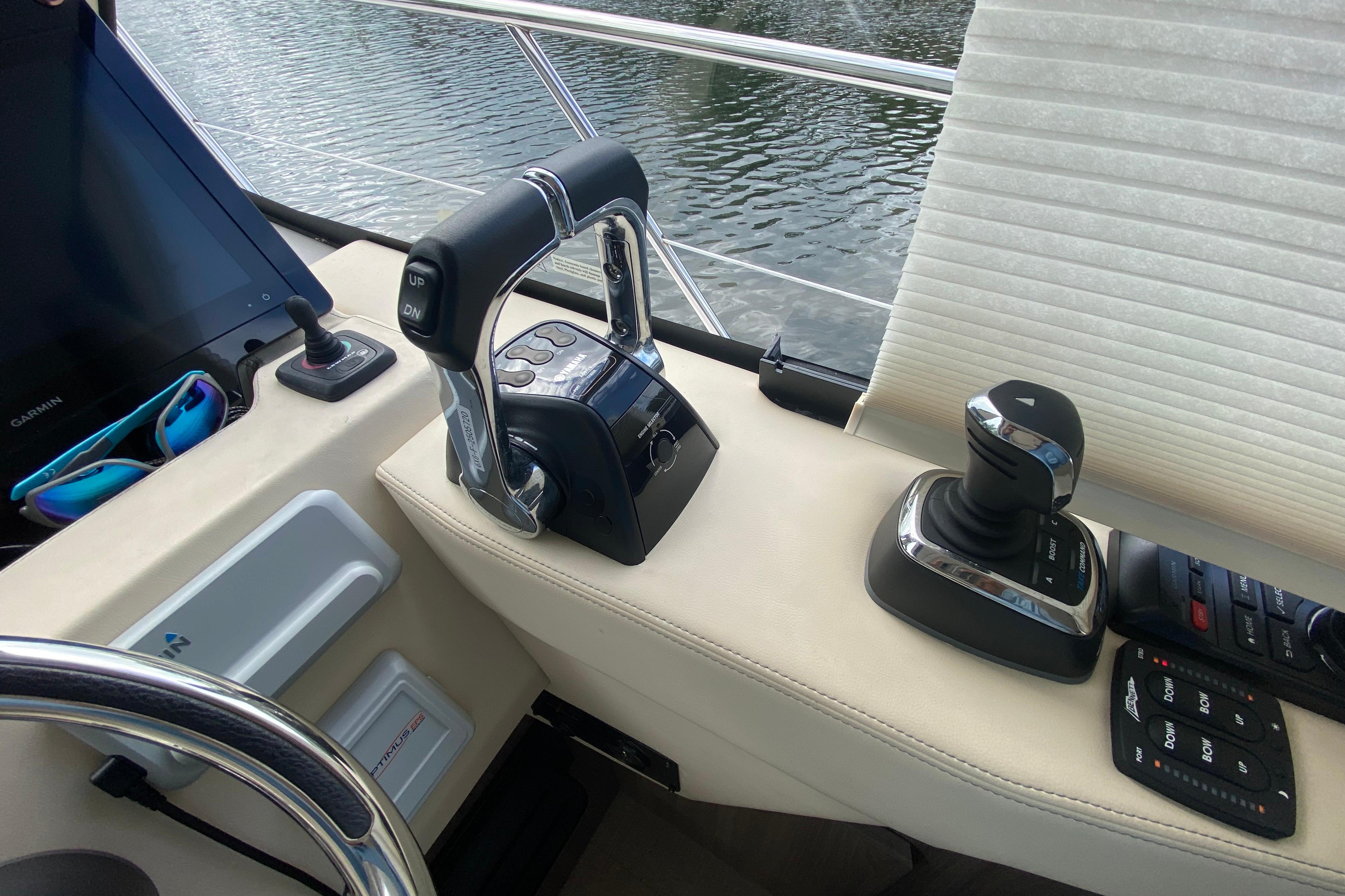 Control panel of a 2021 Regal 38 XO yacht with throttle and joystick.
