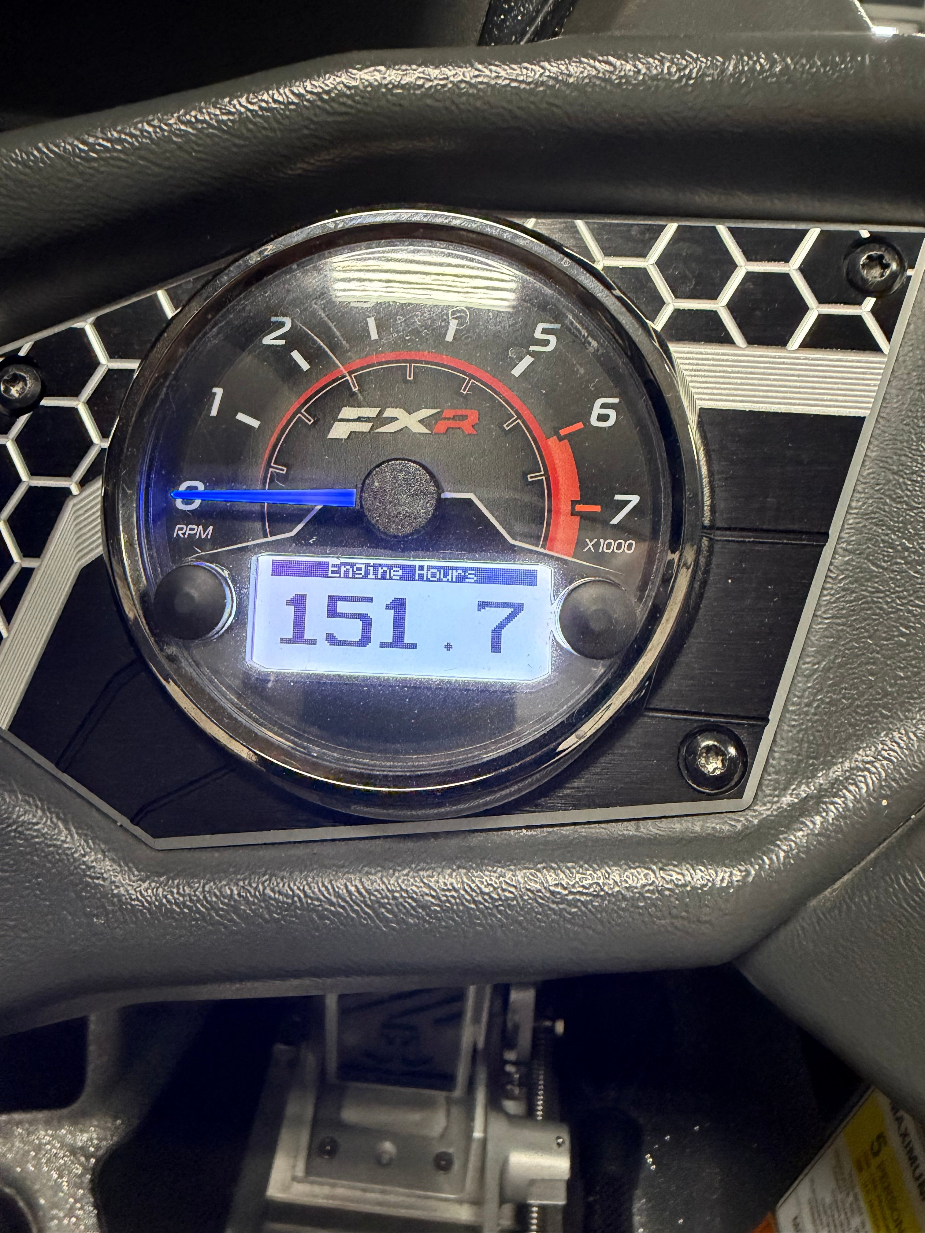 Close-up of a boat tachometer showing 151.7 engine hours.