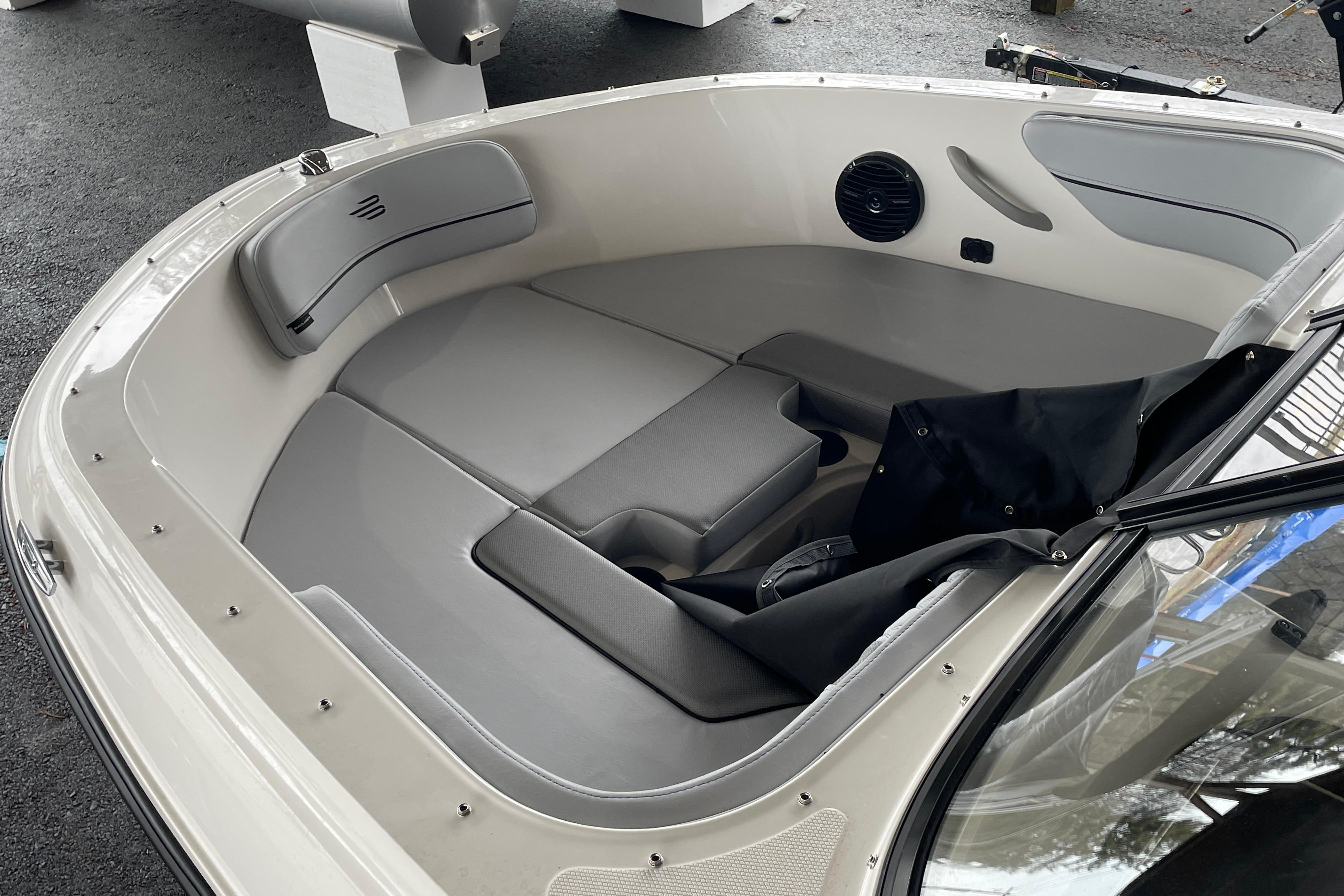 2026 Bayliner VR4 Bowrider OB interior with gray seating and speaker detail.