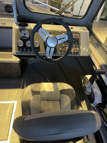 2024 Spartan 185 Astoria boat cockpit with steering wheel and control panel.