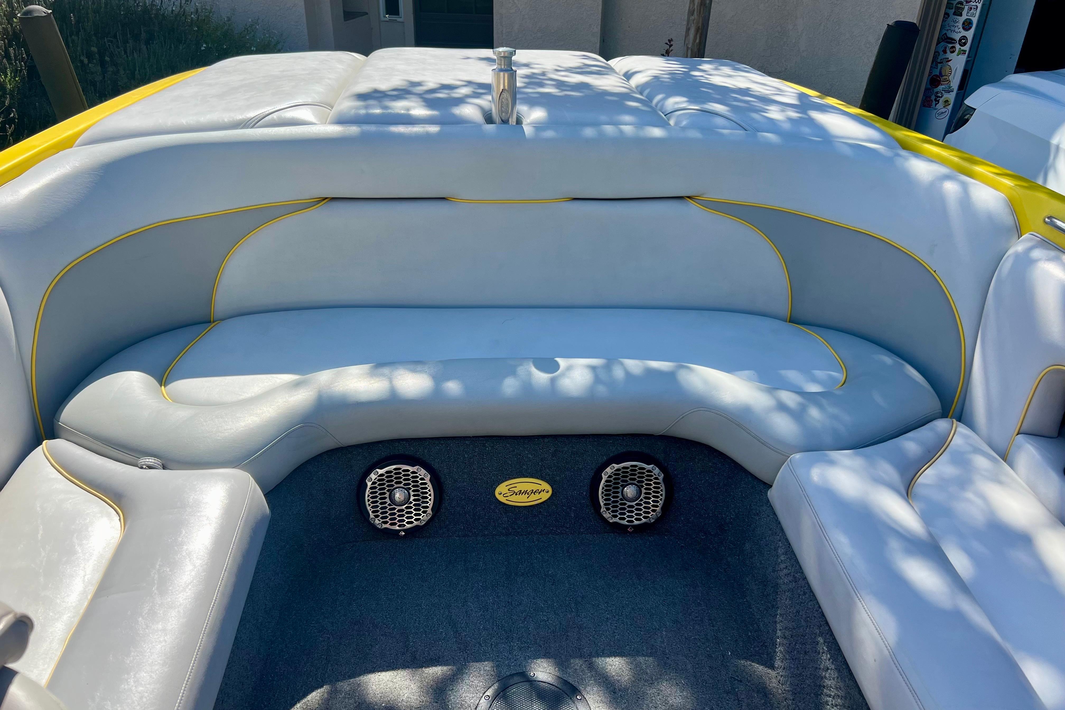 2006 Sanger V230 boat interior with gray seating and yellow accents.