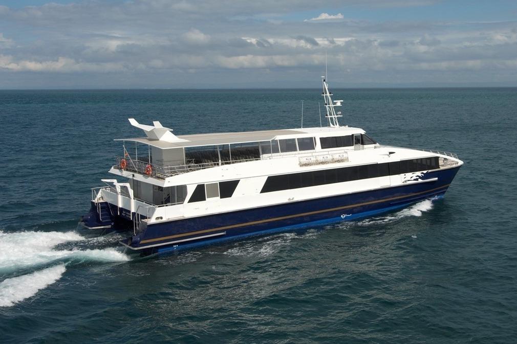 Custom 2007 fast passenger ferry cruising on open sea under cloudy sky.