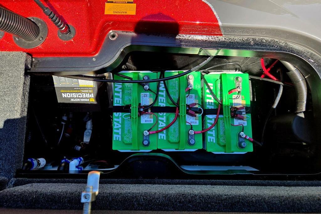 Battery compartment of a 2026 Skeeter ZXE20 with Interstate batteries and wiring.