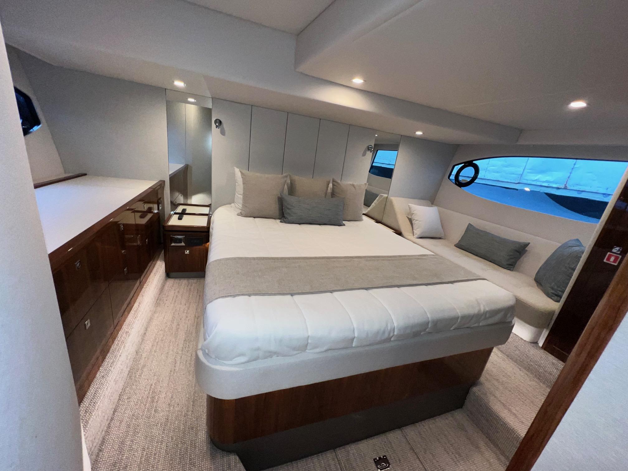 Luxurious interior of 2023 Riviera 4600 Sport Yacht Platinum Edition with elegant bedroom design.