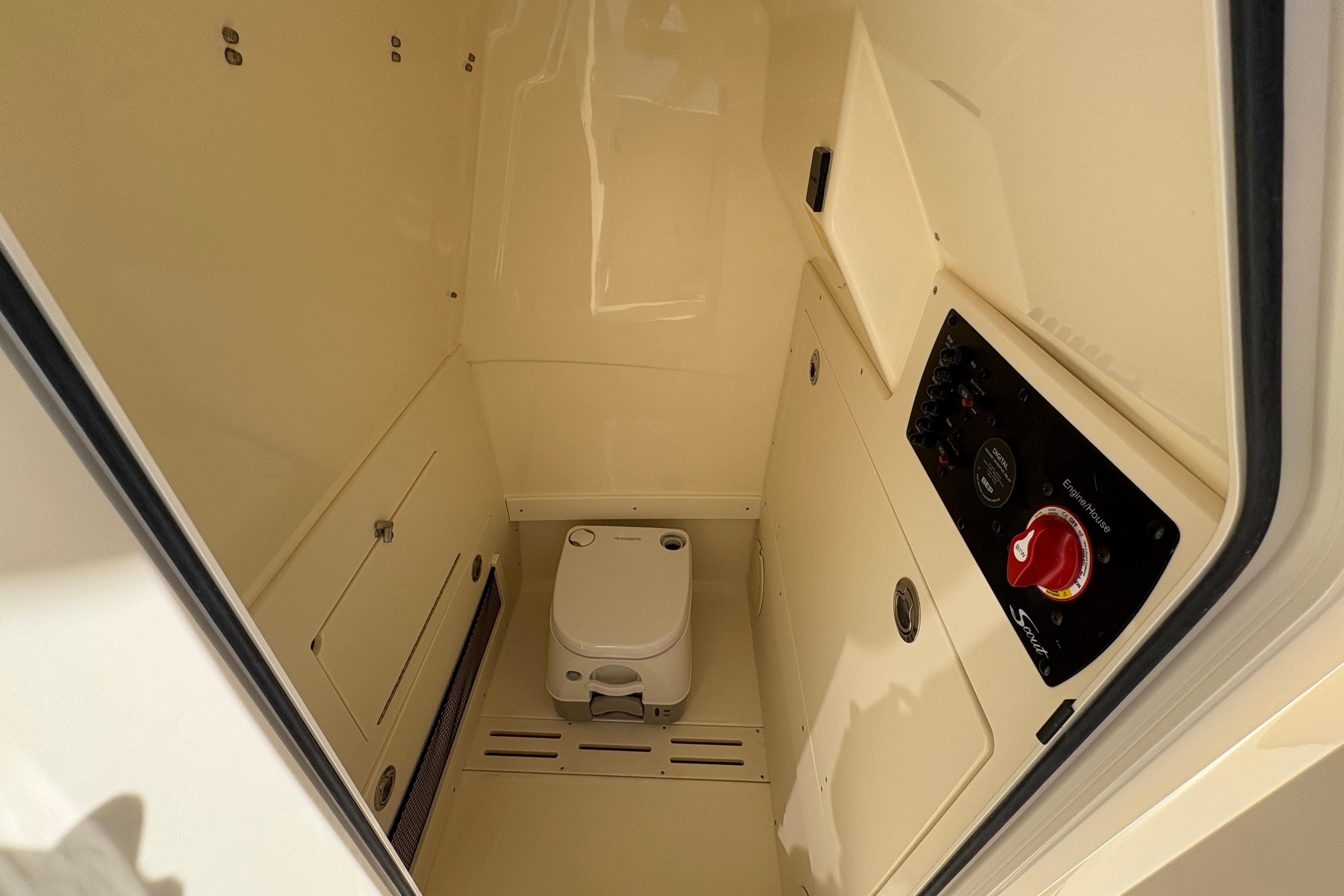 2026 Scout 220 XSF boat interior with compact toilet and control panel.