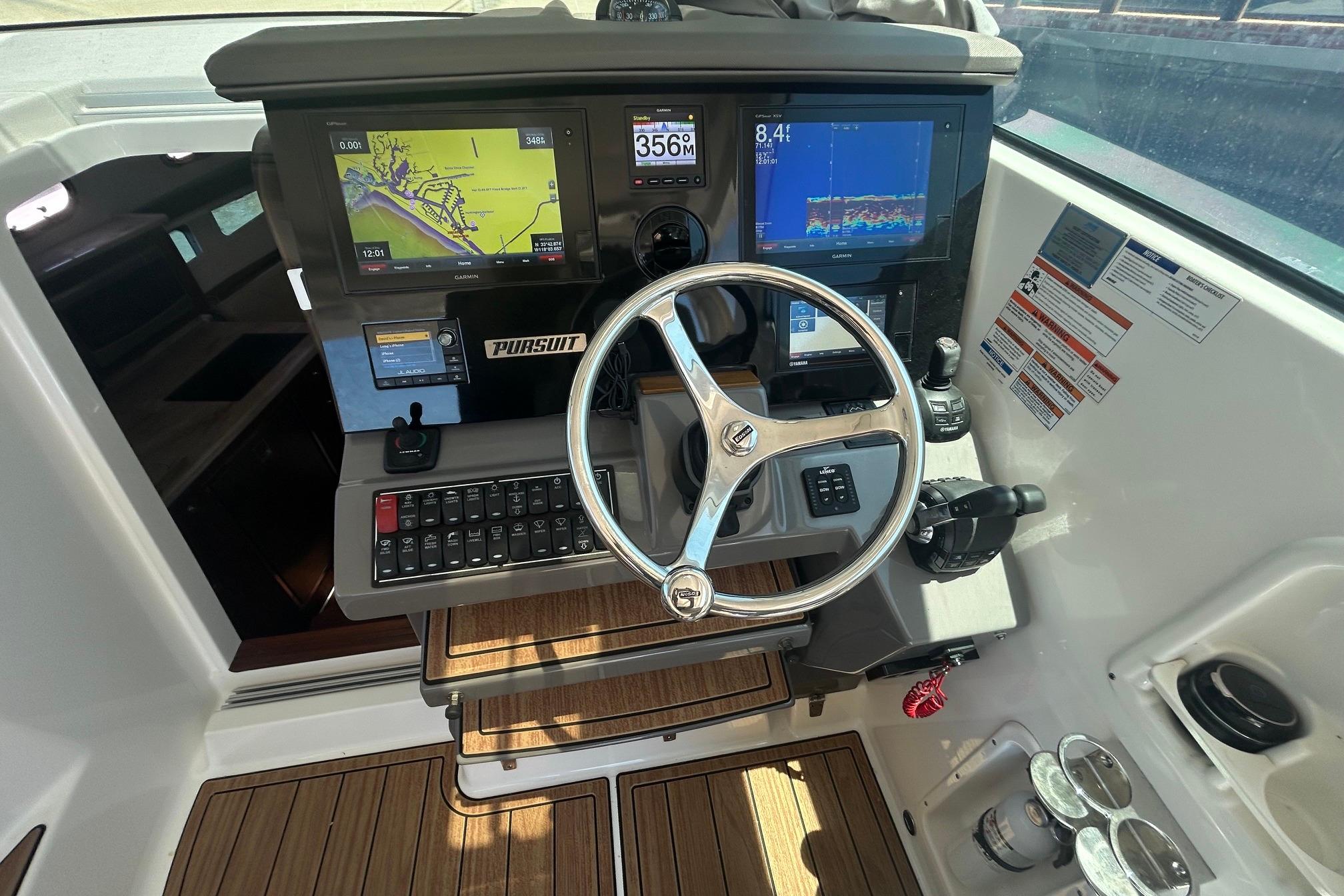 2019 Pursuit OS 355 Offshore helm with navigation screens and steering wheel.