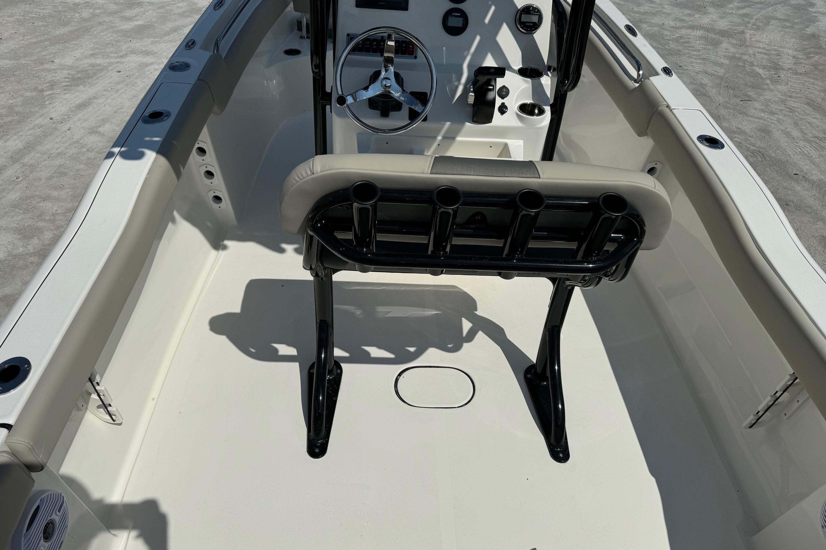 2025 Key West 203 FS boat interior with steering wheel and seating.