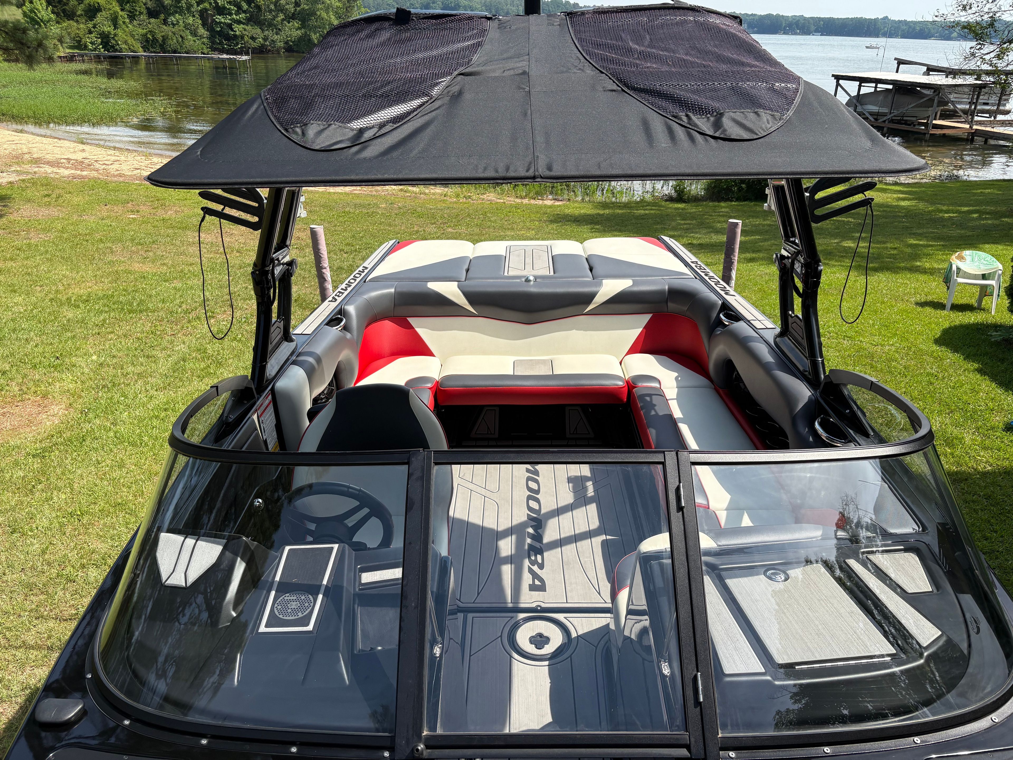 2021 Moomba Craz boat with open canopy by the lakeside.