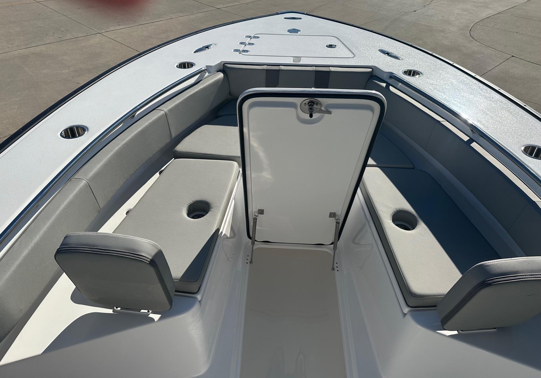 2025 Cape Horn 28XS boat interior with cushioned seating and storage compartment.