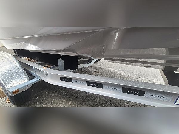2023 Sea Born LX22 Center Console boat on a Venture trailer, close-up view.