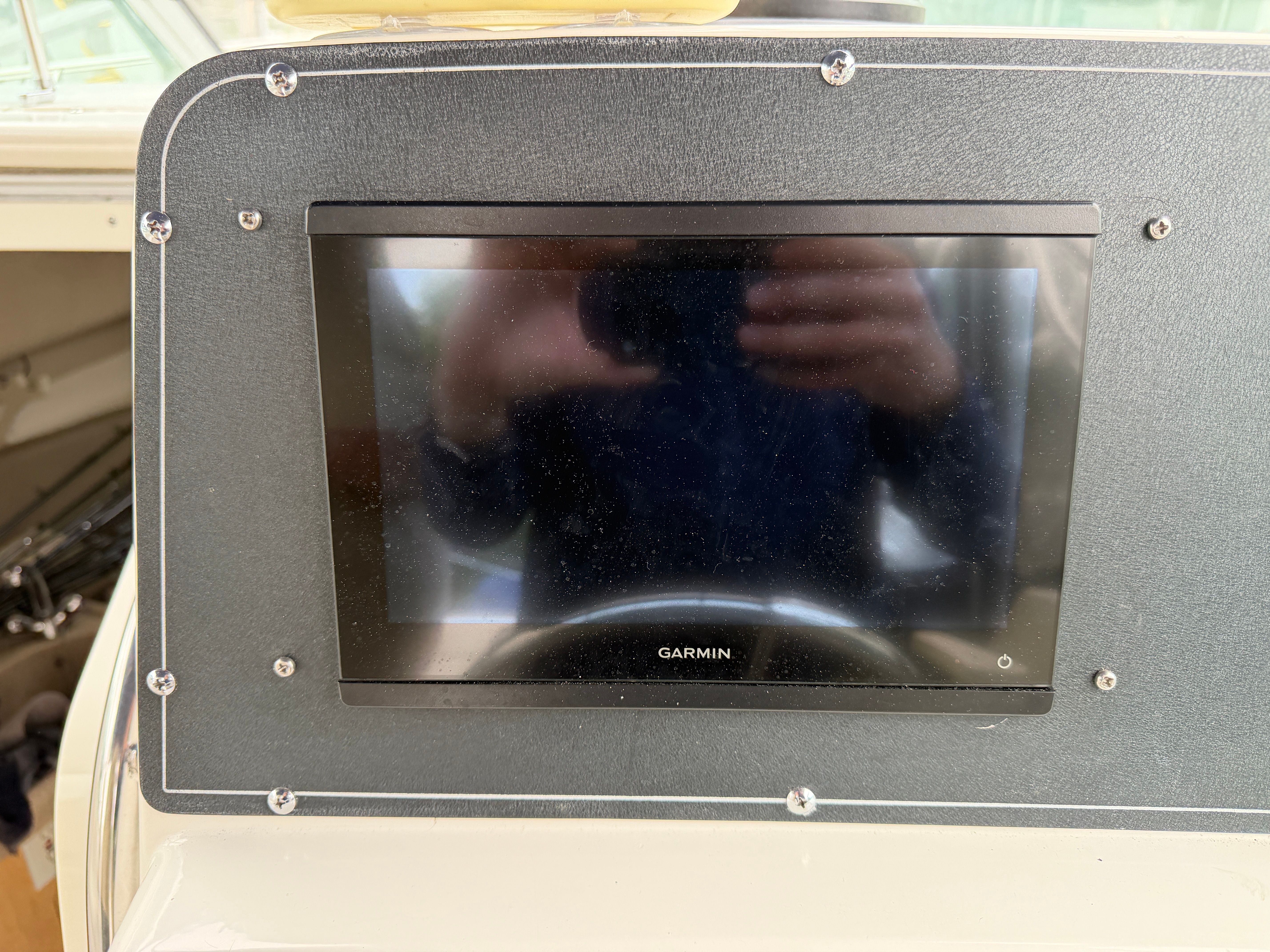 A Garmin navigation device is embedded in the dashboard of a boat.