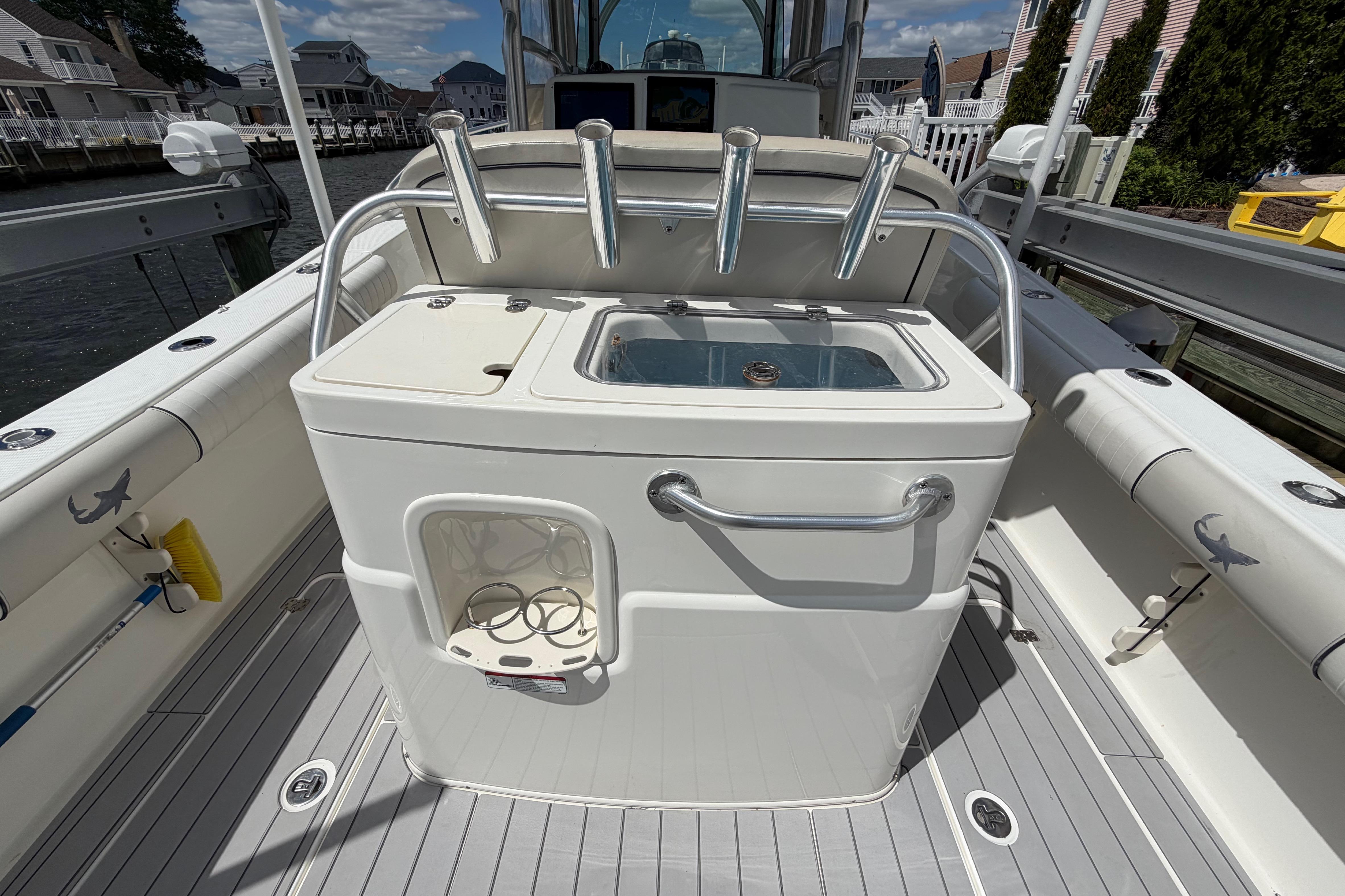 2017 Mako 284 Center Console boat interior with fishing rod holders and storage.