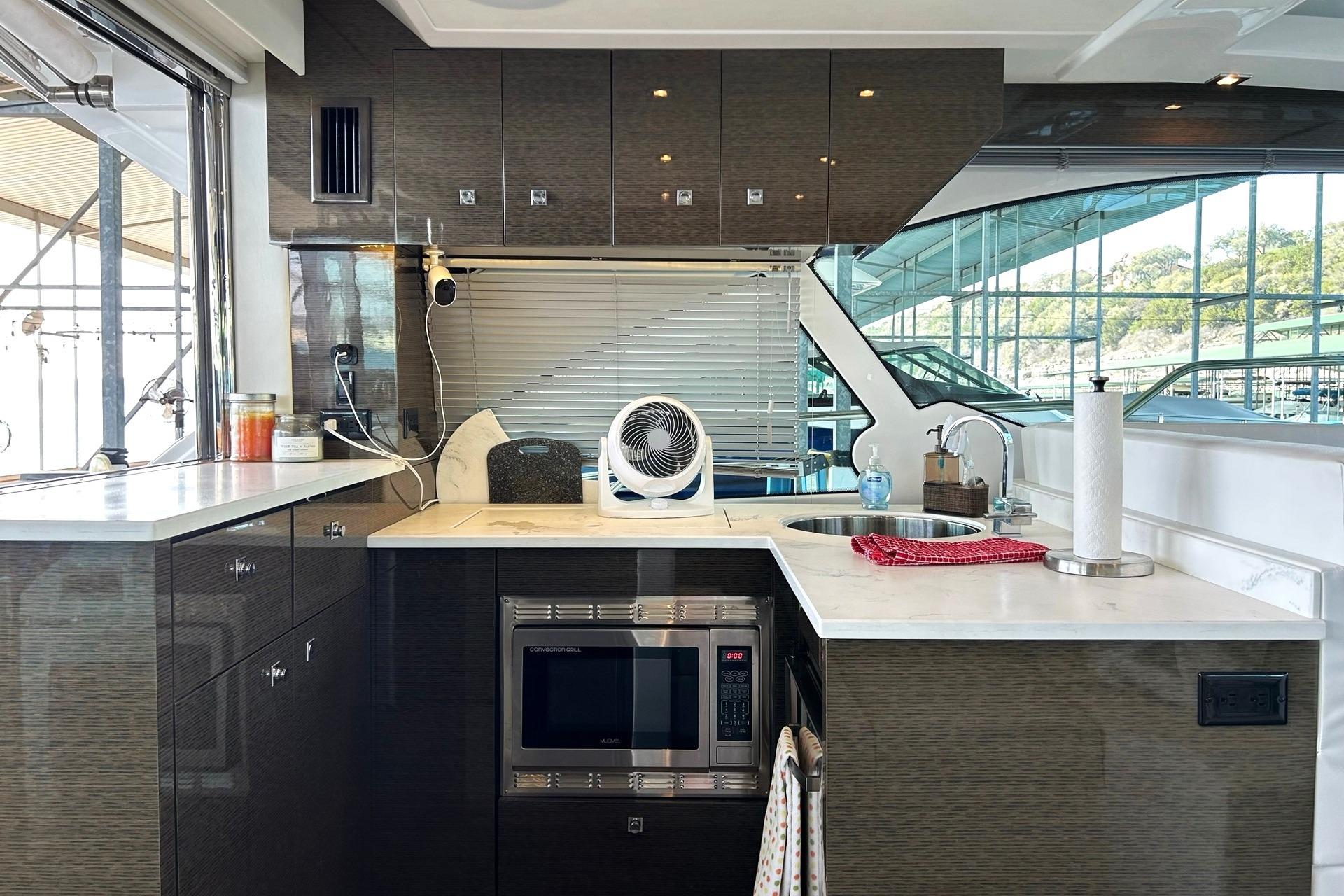 2021 Cruisers Yachts 50 Cantius kitchen with modern appliances and sleek cabinetry.