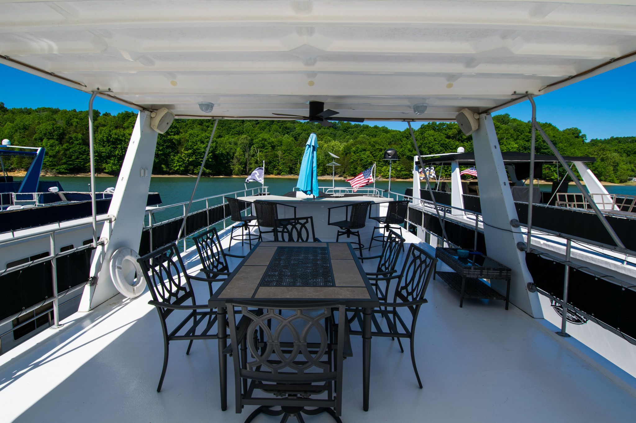2003 Lakeview 16x70 houseboat with deck and chairs on the water.