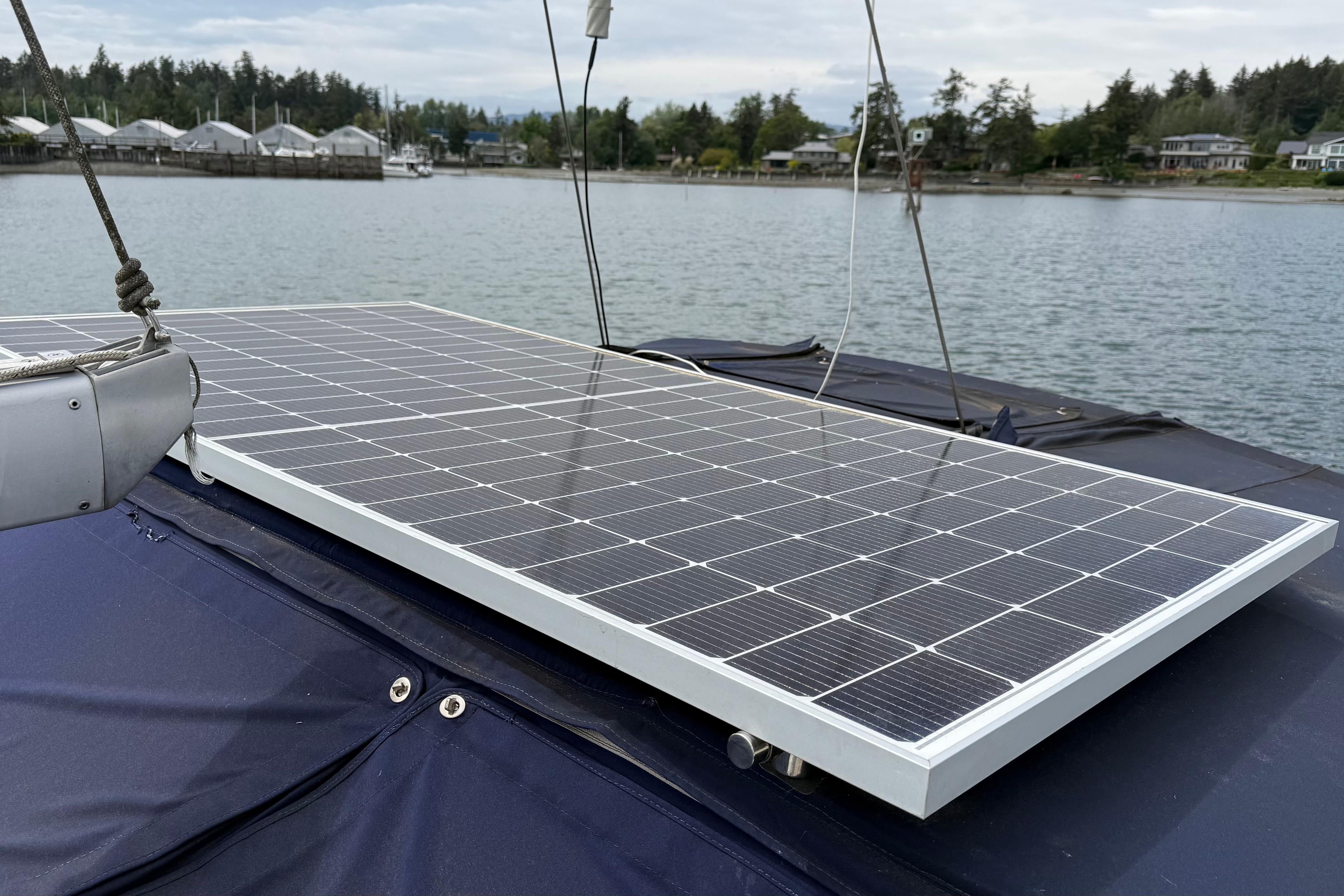 Solar panel on 2005 Catalina 36 MkII sailboat, docked in a serene marina setting.