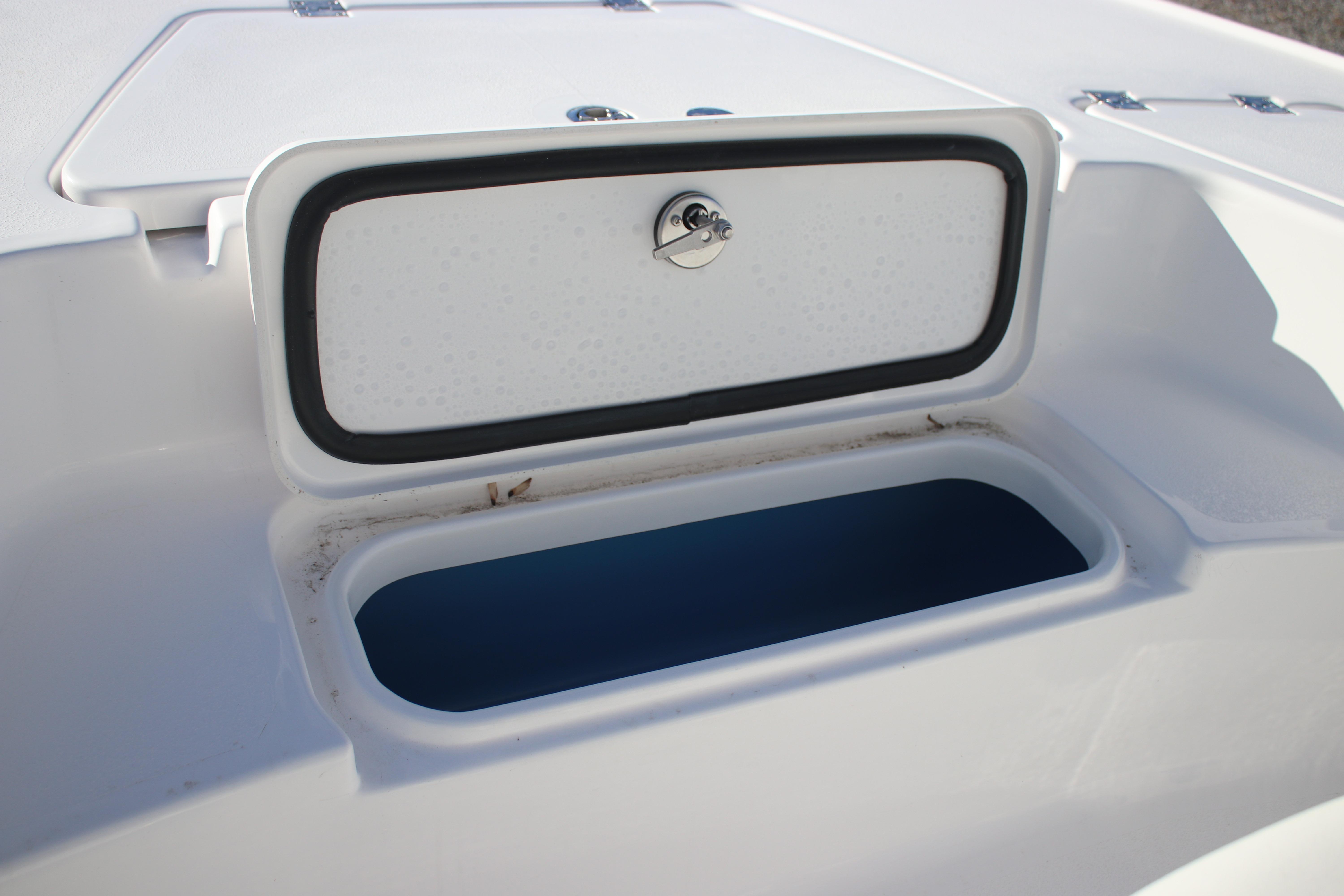 Open storage compartment on 2026 Tidewater 2210 Carolina Bay boat.