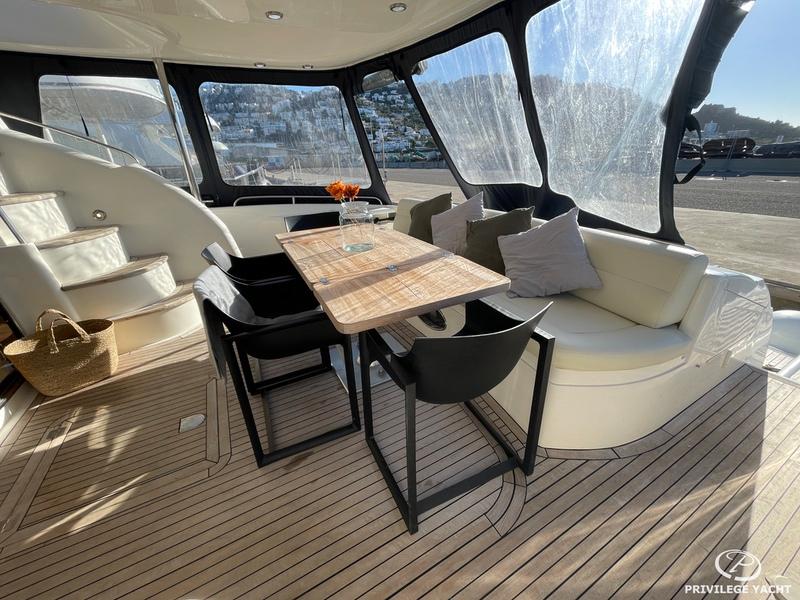 Luxurious 2001 Sunseeker Manhattan 74 yacht interior with elegant seating and dining area.