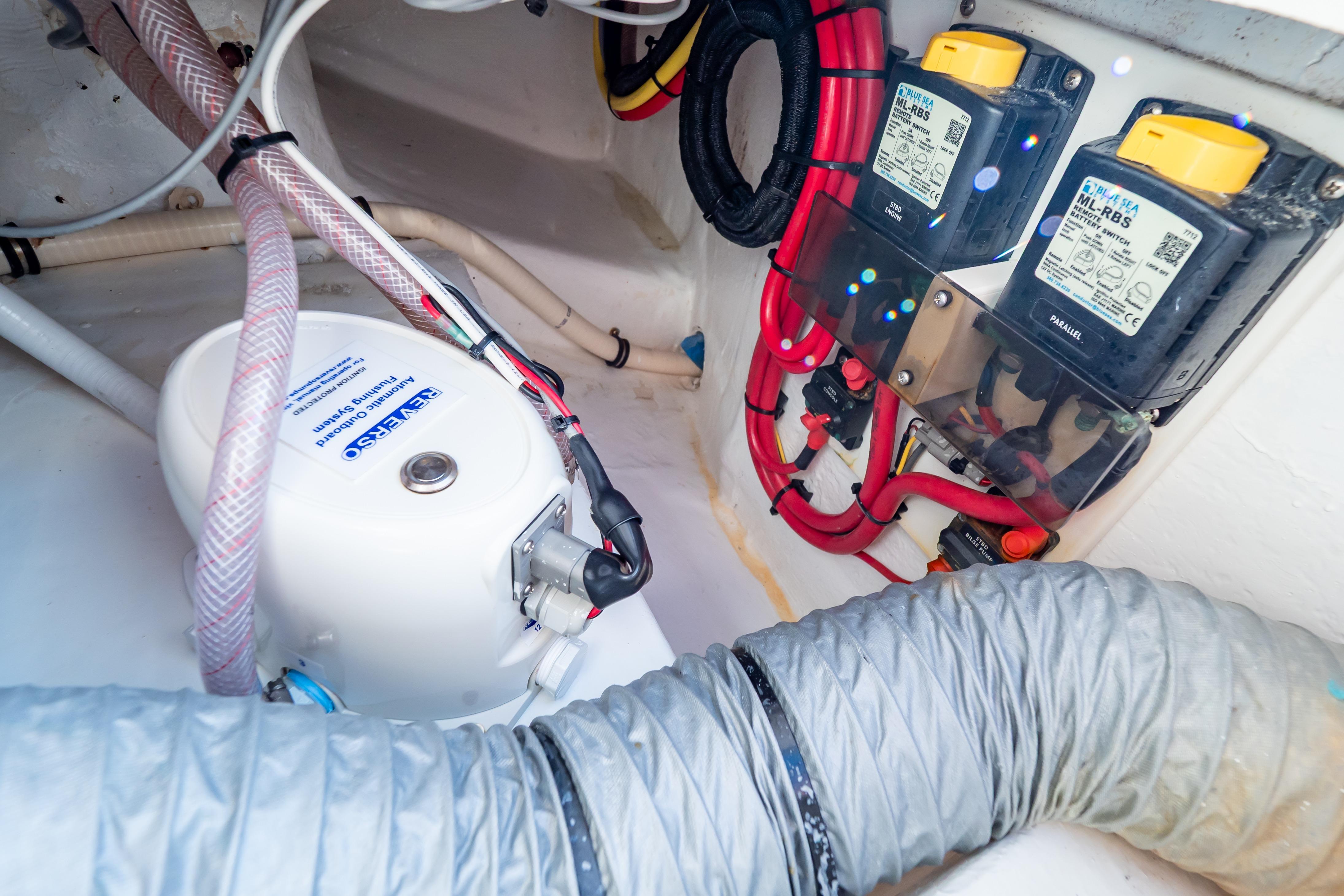Electrical system components inside a 2014 Intrepid 375 Walkaround boat, featuring wiring and switches.