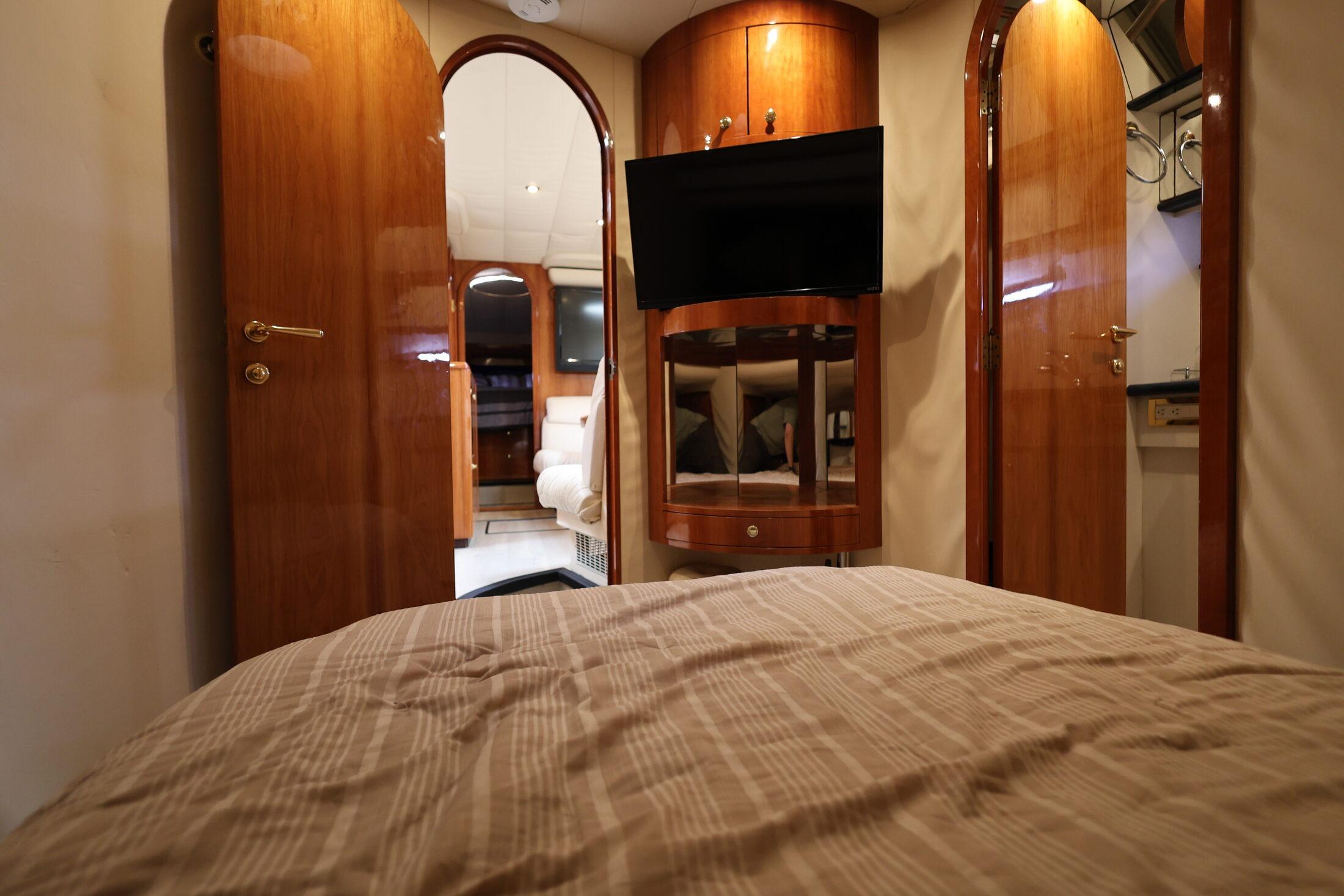 Luxurious interior of 1999 Neptunus 54 Express yacht with wood finishes and modern amenities.