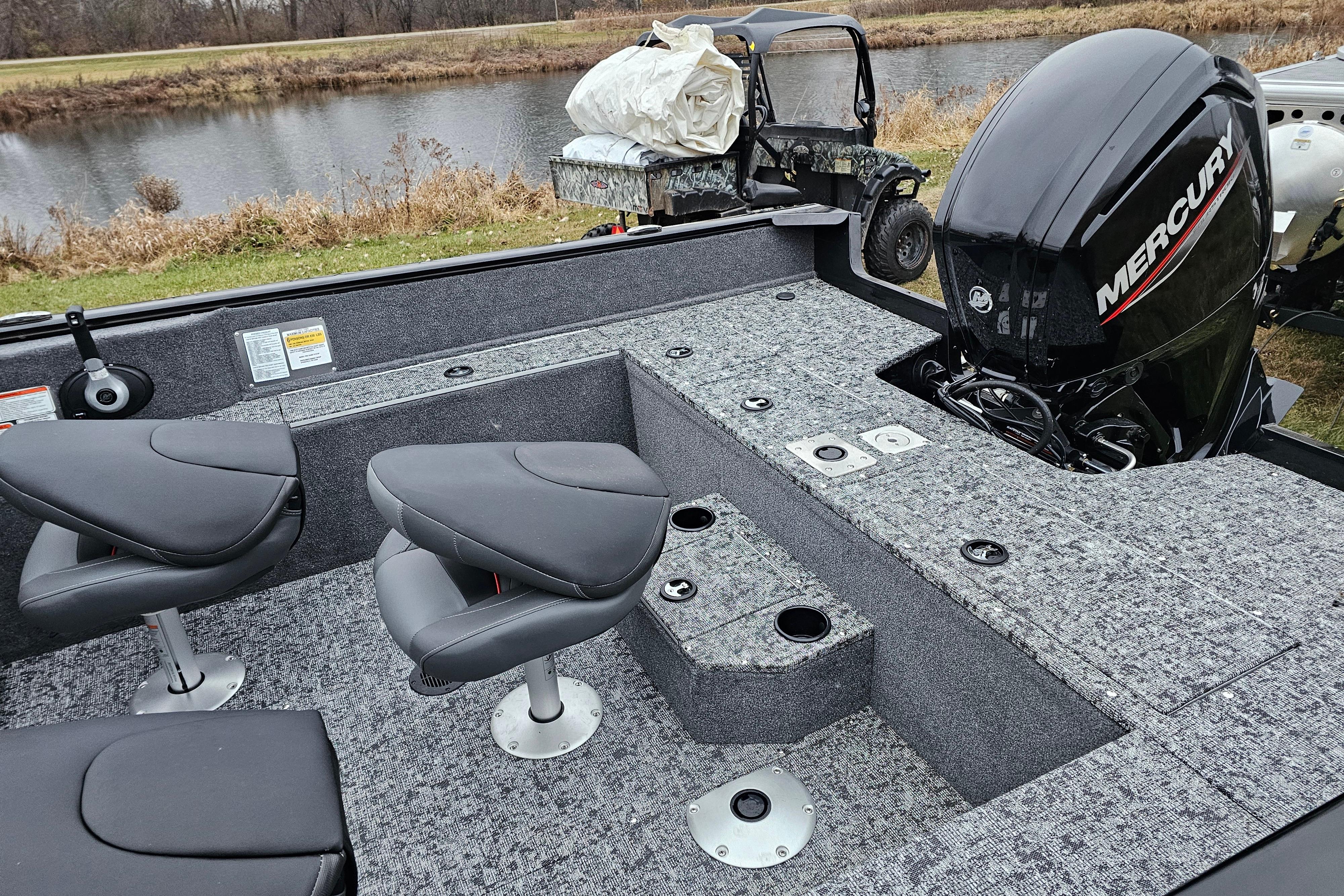 2026 Tracker Pro Guide V-175 WT boat interior with Mercury engine by a lake.