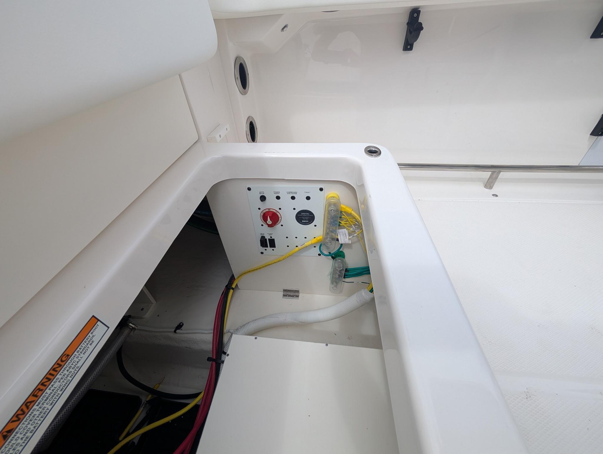 2025 Robalo R222 Explorer boat compartment with wiring and control panel.