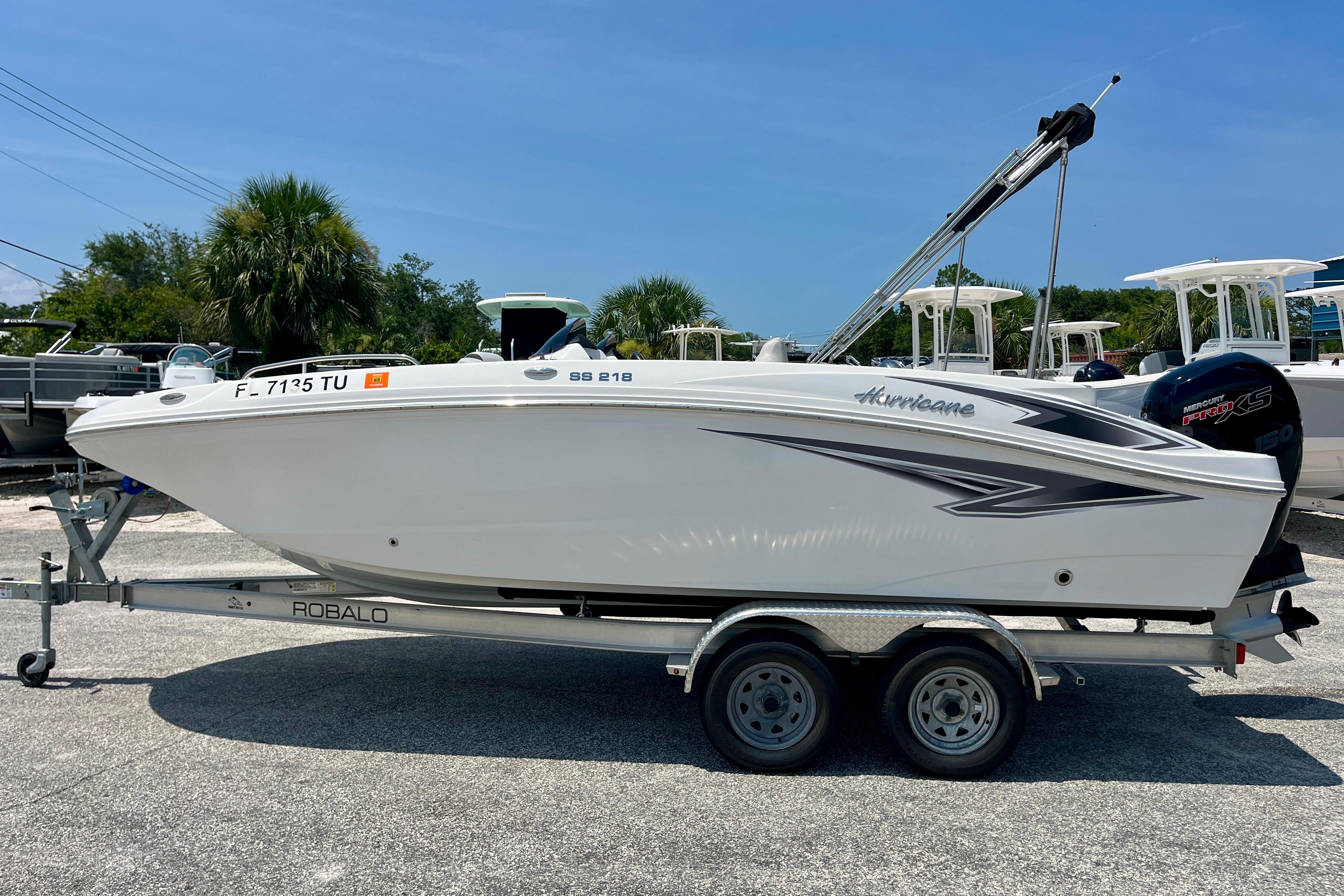 2024 Hurricane Sundeck Sport 218 OB boat on trailer, parked outdoors.