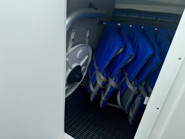 Storage compartment with blue life jackets on a 2018 Monterey 258 Super Sport boat.