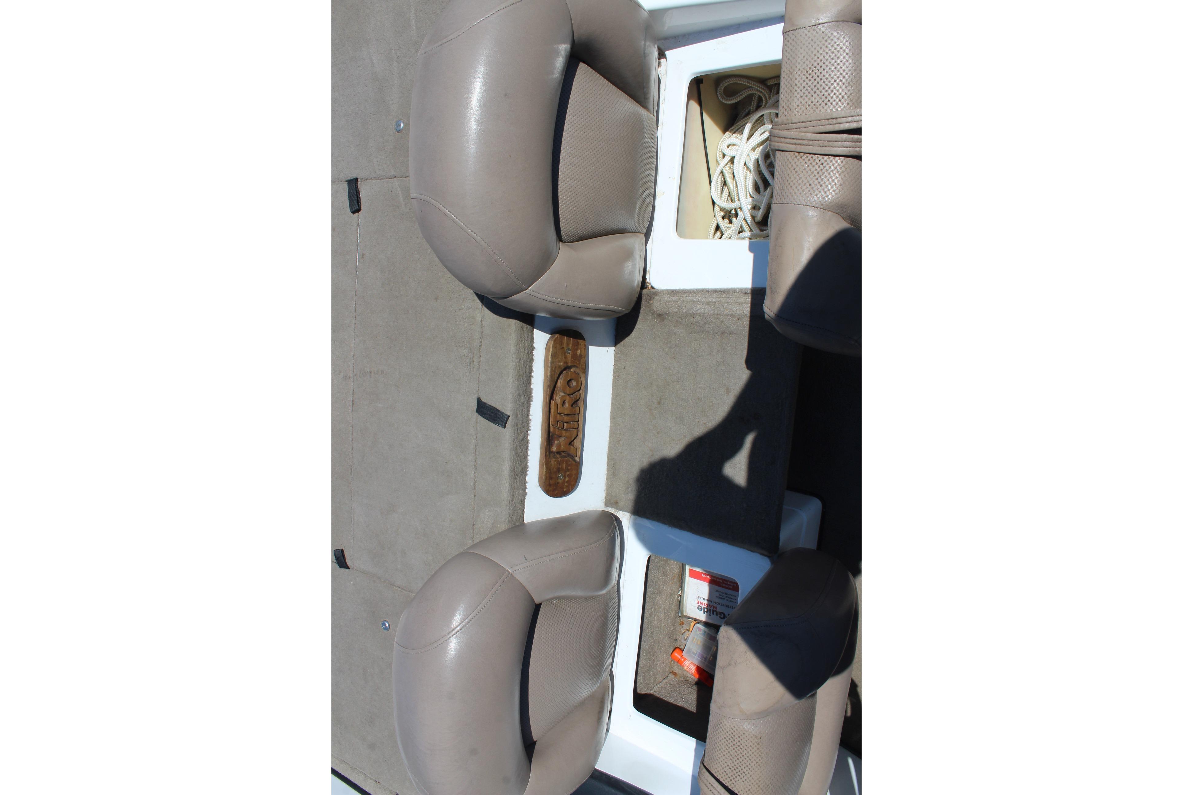Interior of a 2003 Nitro NX 750 SC boat showing seats and storage compartments.