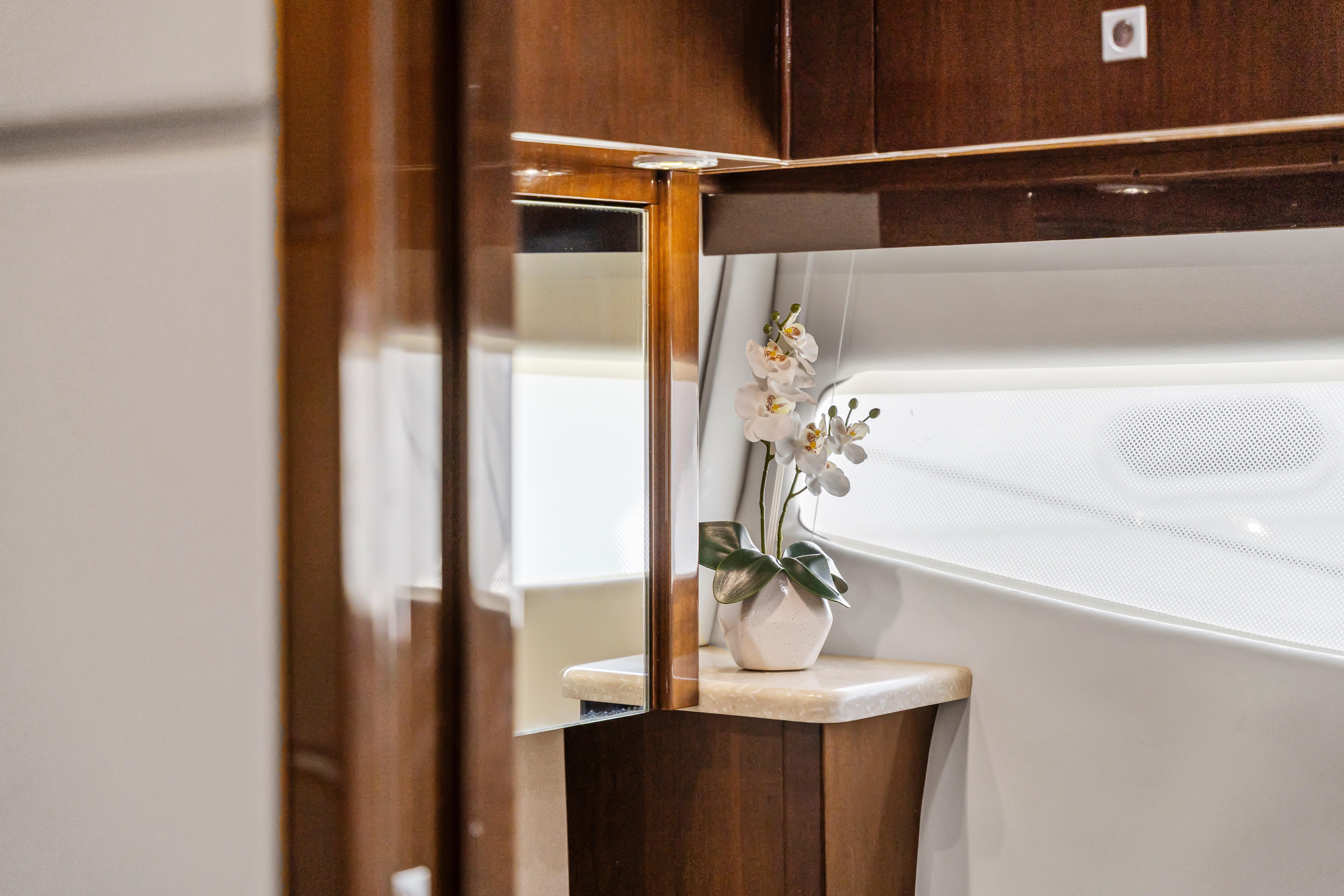 Luxurious interior of 2007 Marquis 55 LS yacht with elegant wood finish and floral decor.