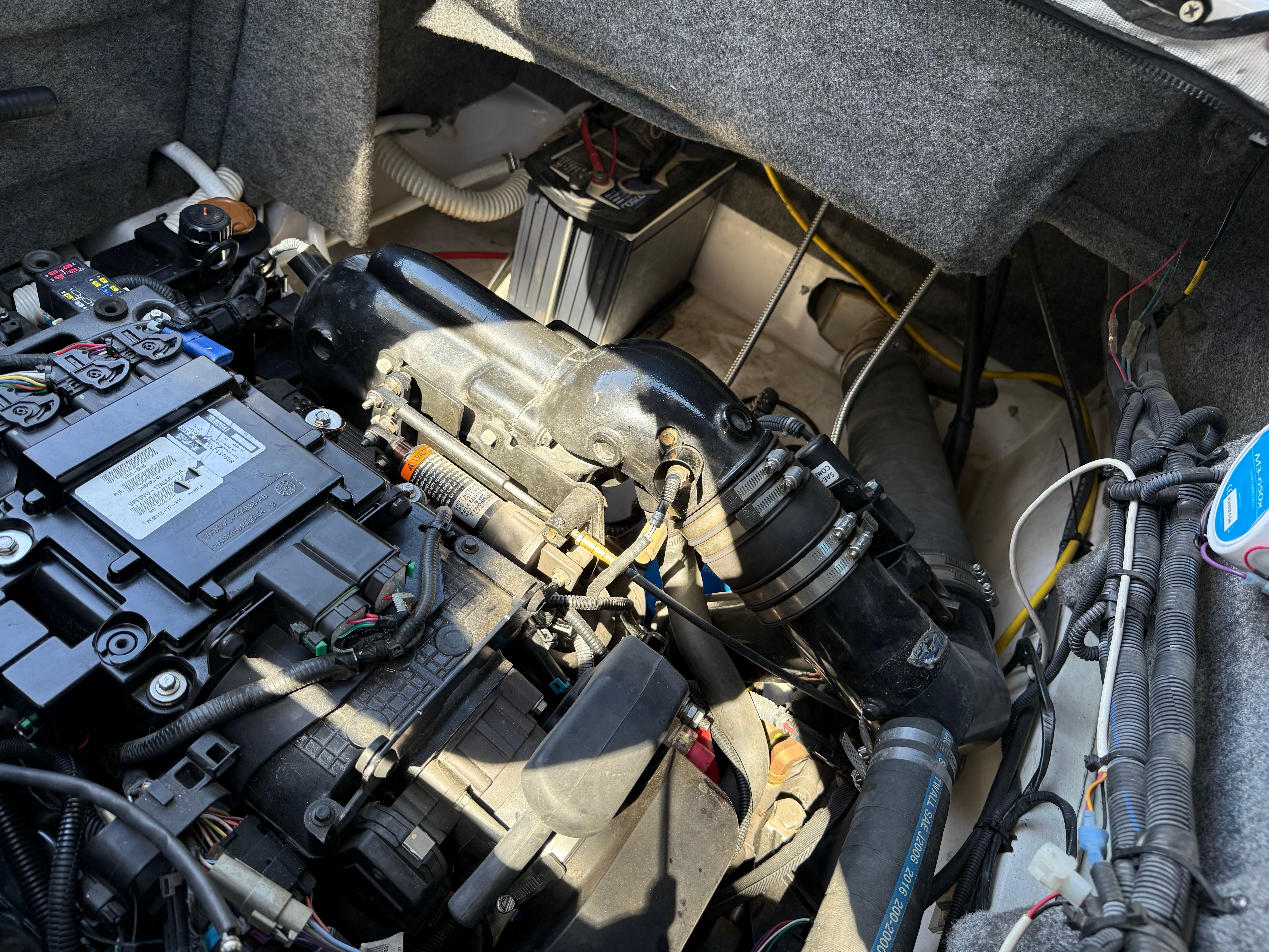 Engine compartment of a 2019 Four Winns H260 boat with visible components.