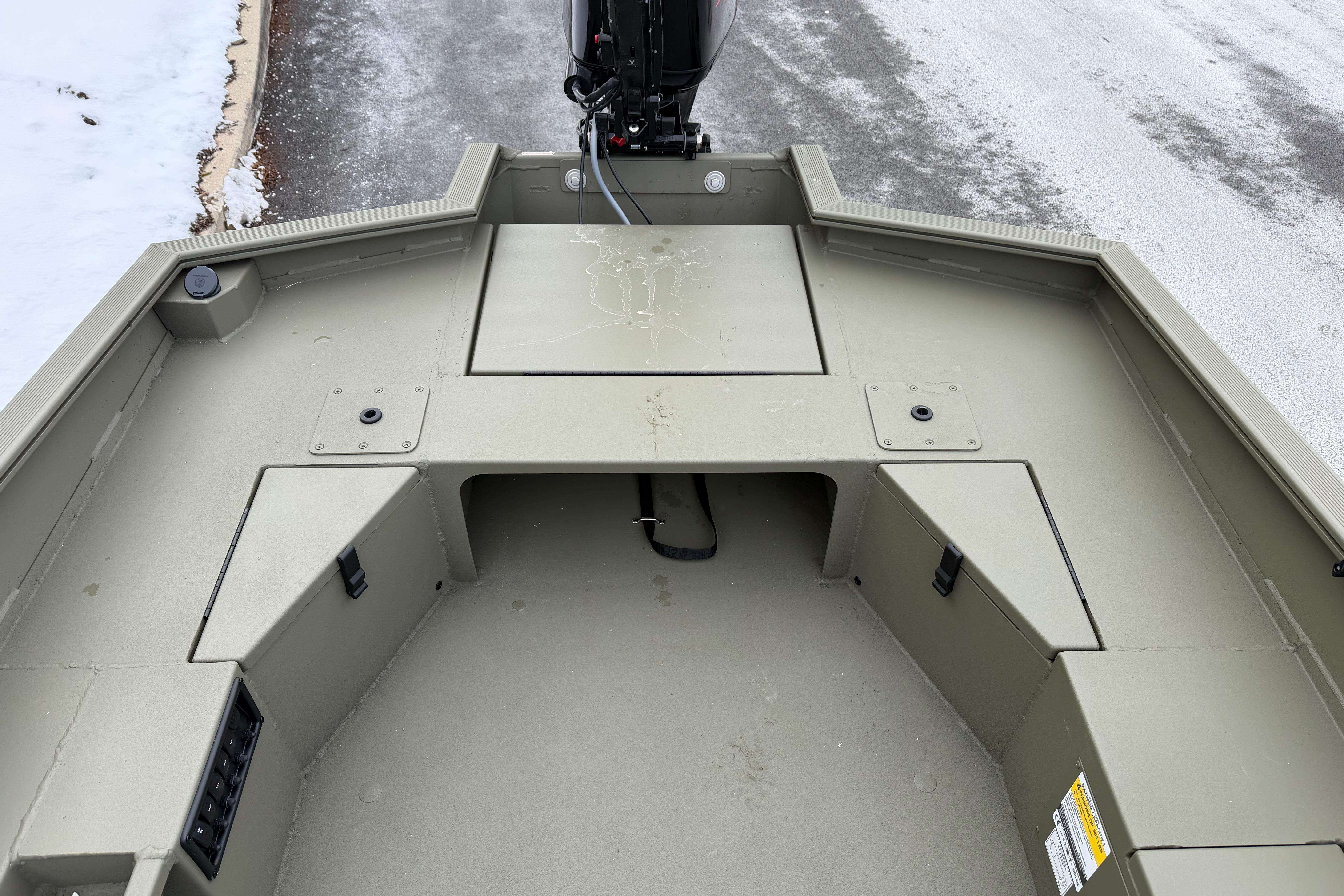 2026 Tracker Grizzly 1756 T Marsh boat interior with storage compartments and motor.