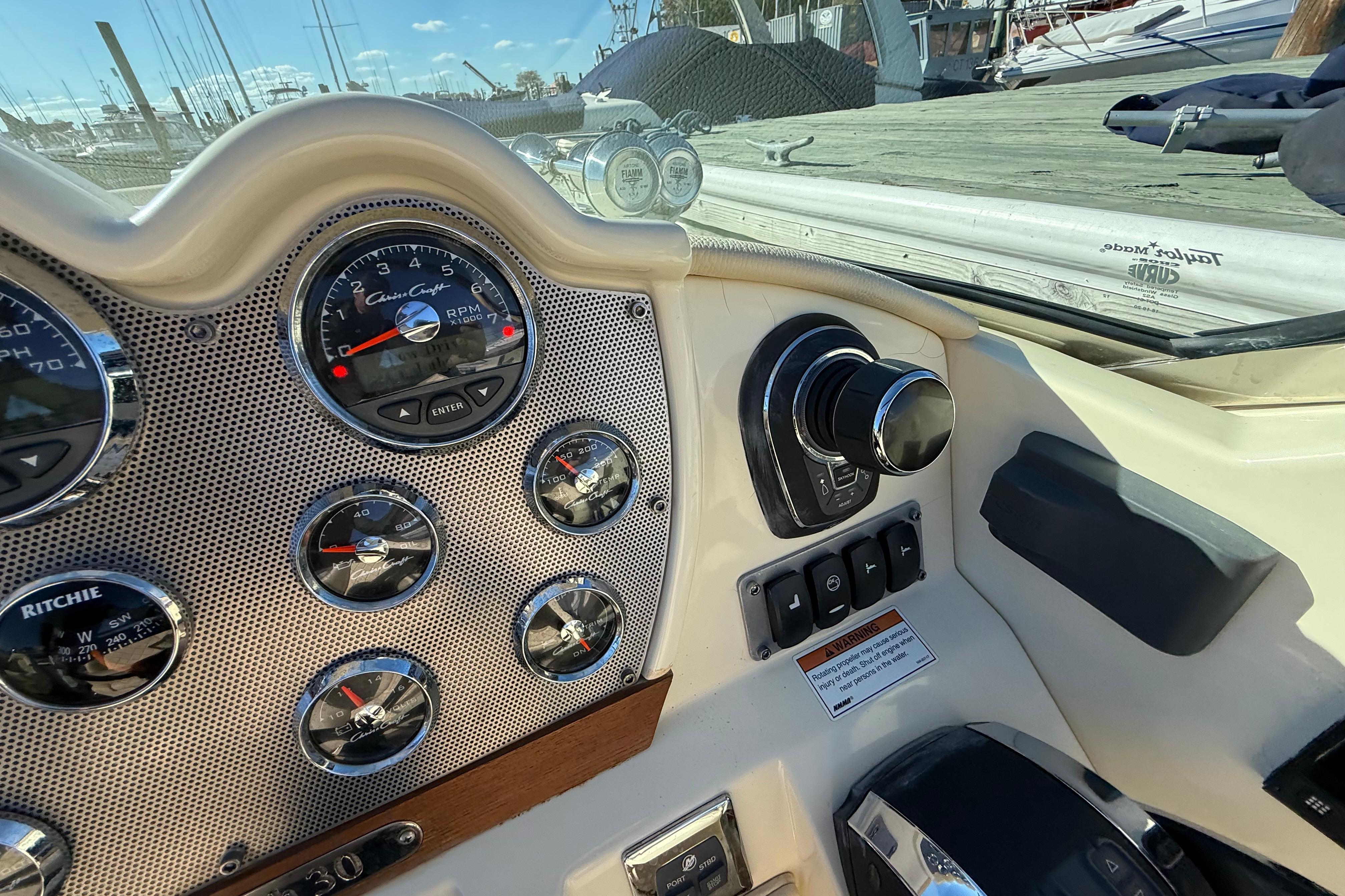 Dashboard of a 2018 Chris-Craft Launch 30 boat with gauges and controls.