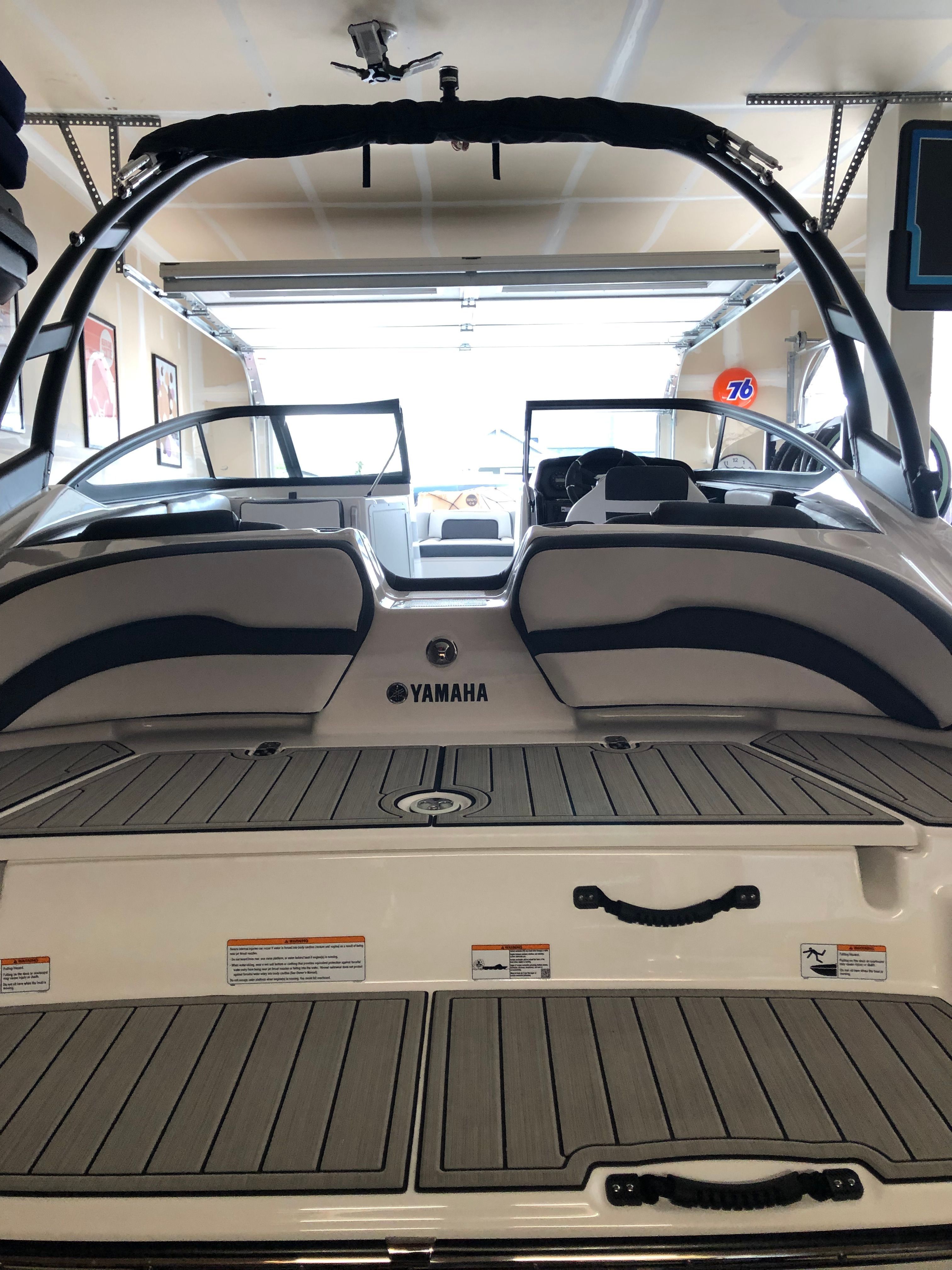 A Yamaha AR195 boat in a garage, featuring a gray deck and black accents.