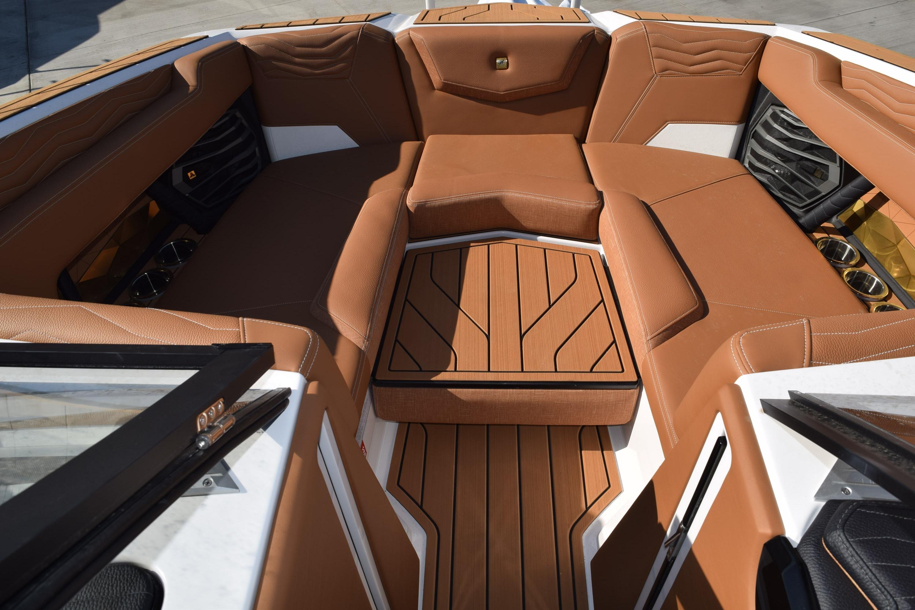 2026 Nautique Super Air Nautique G23 boat interior with luxurious brown seating and wood accents.