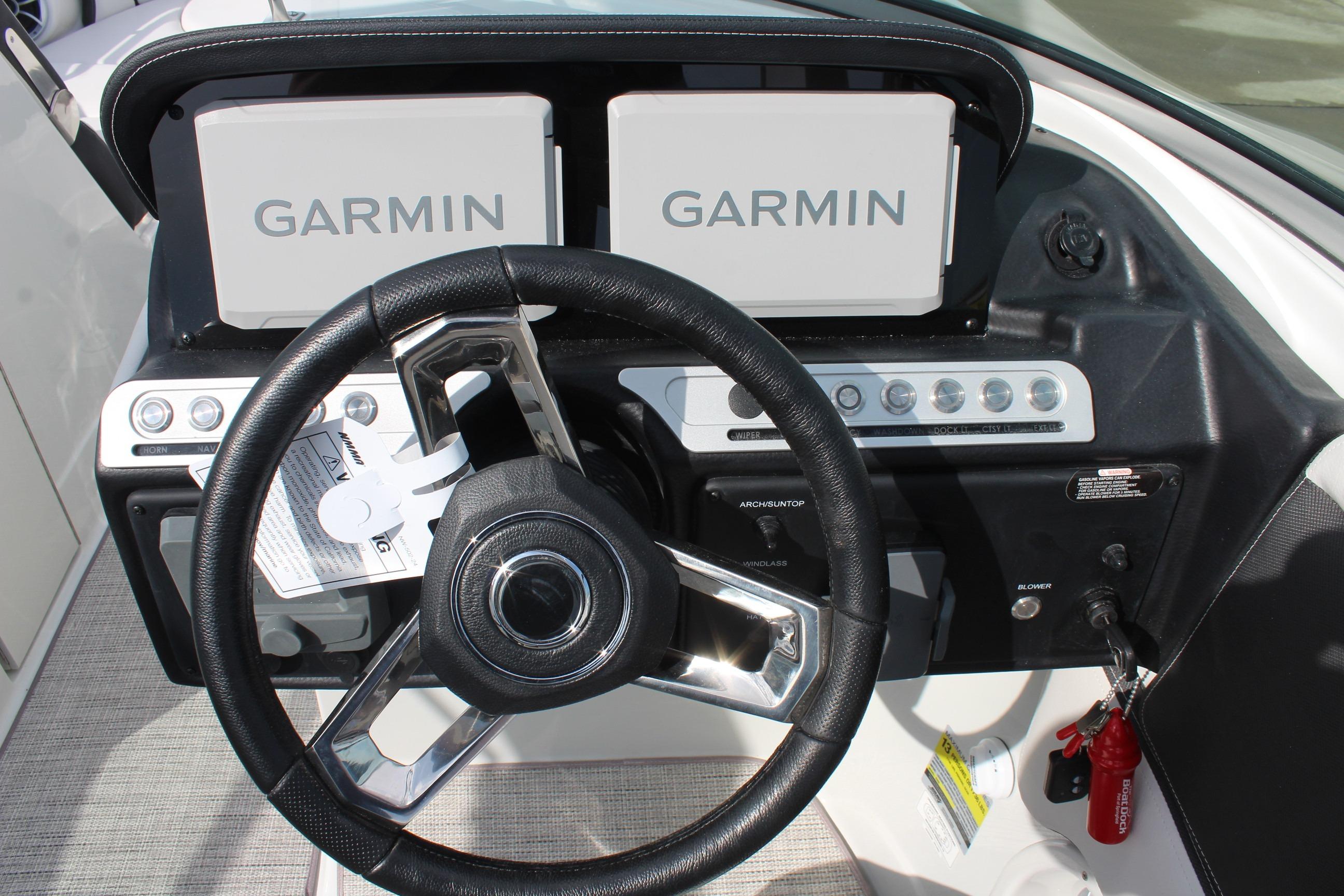 Steering wheel and Garmin displays on 2026 Crownline Eclipse E255 boat dashboard.
