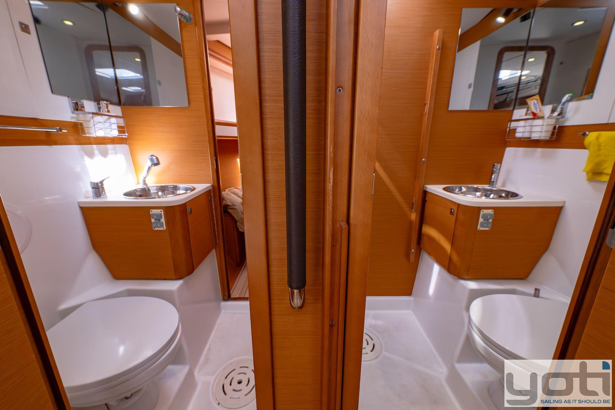 Interior of 2015 Jeanneau 57 yacht bathroom with dual sinks and mirrors.