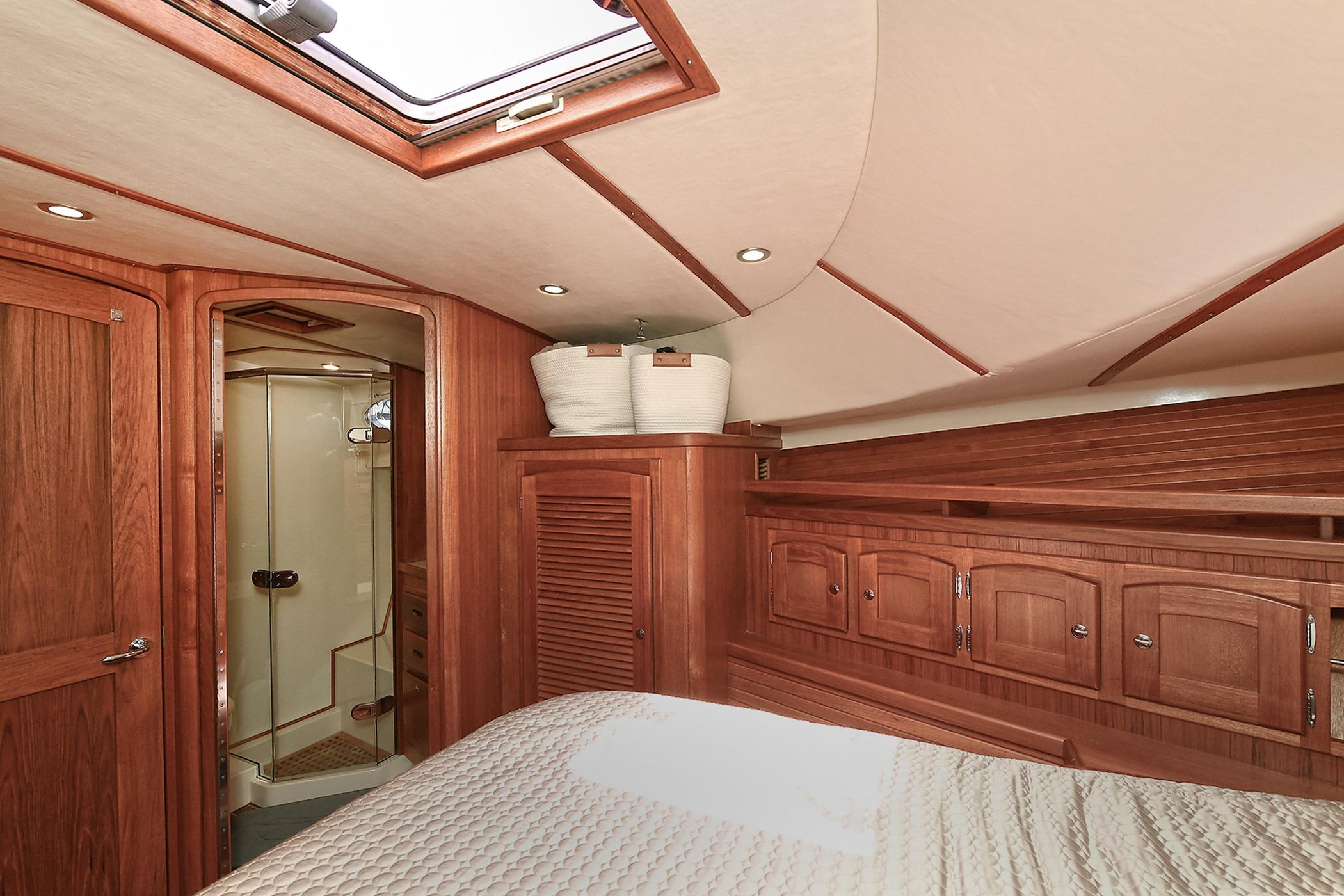 Luxurious 2005 San Juan Downeast Express yacht cabin with wood interior and ensuite bathroom.