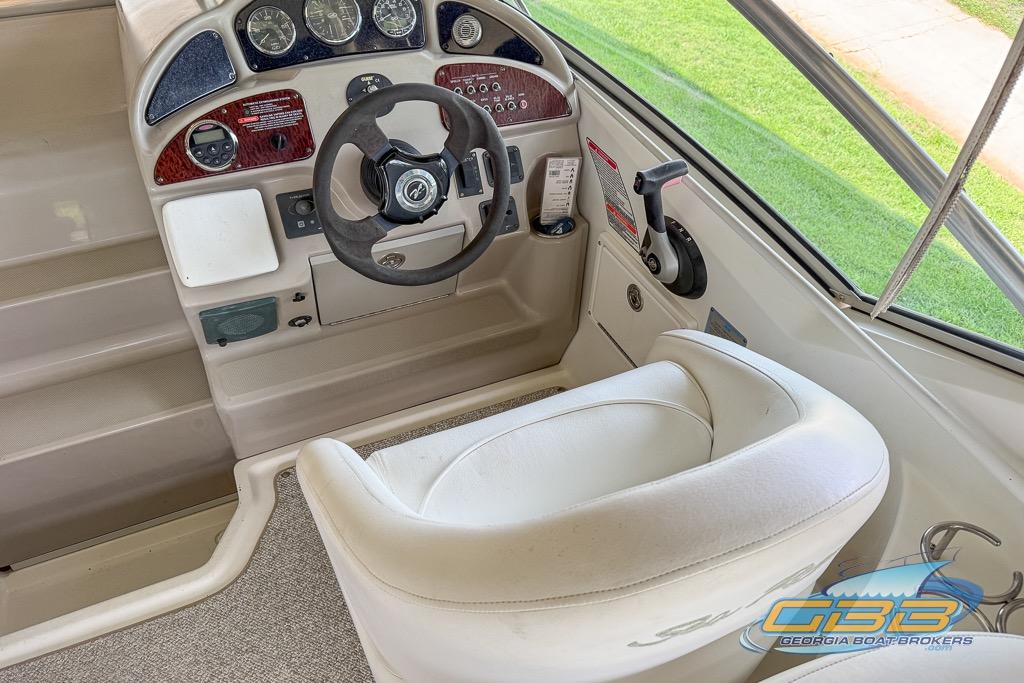 2006 Sea Ray Sundancer 260 helm with steering wheel, gauges, and control panel.