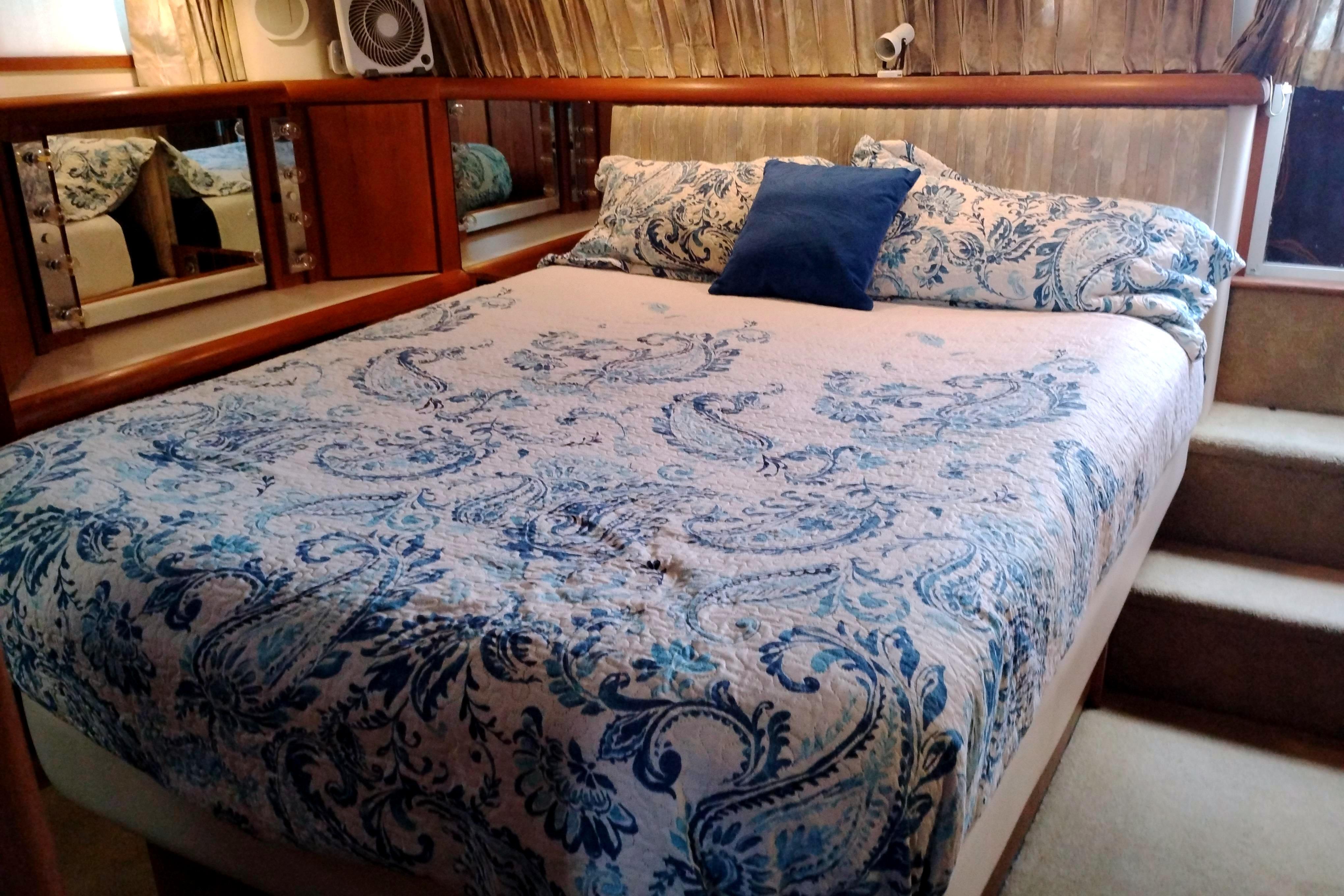 Luxurious bedroom in 1991 Californian 52 Cockpit Motor Yacht with elegant bedding.