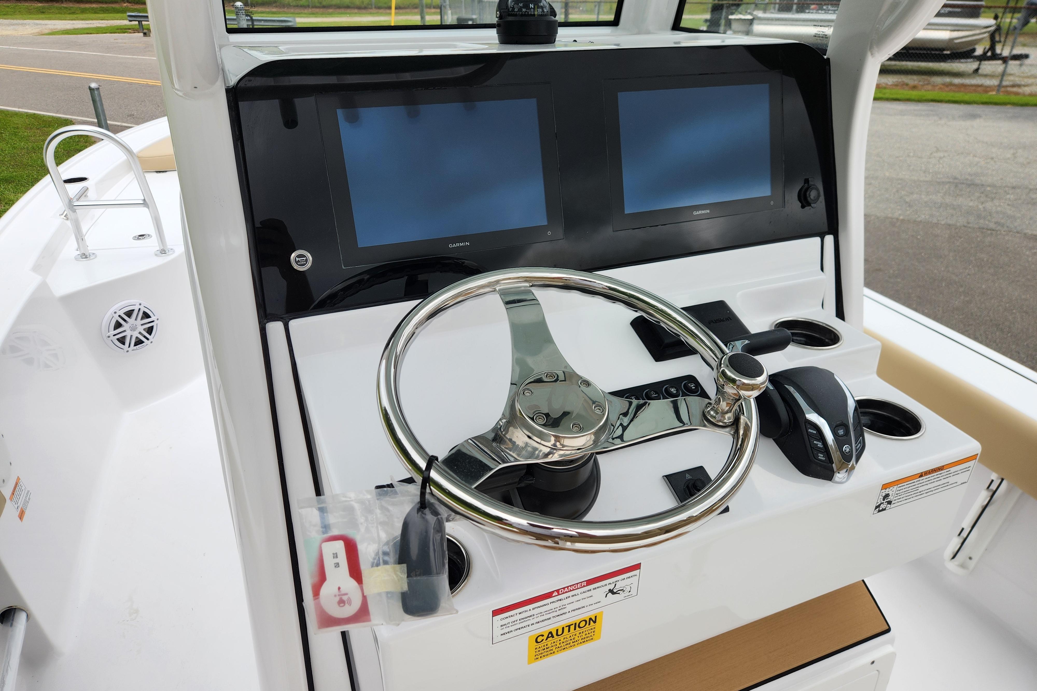 Steering console of 2026 Sportsman Masters 247 Bay Boat with dual screens and controls.