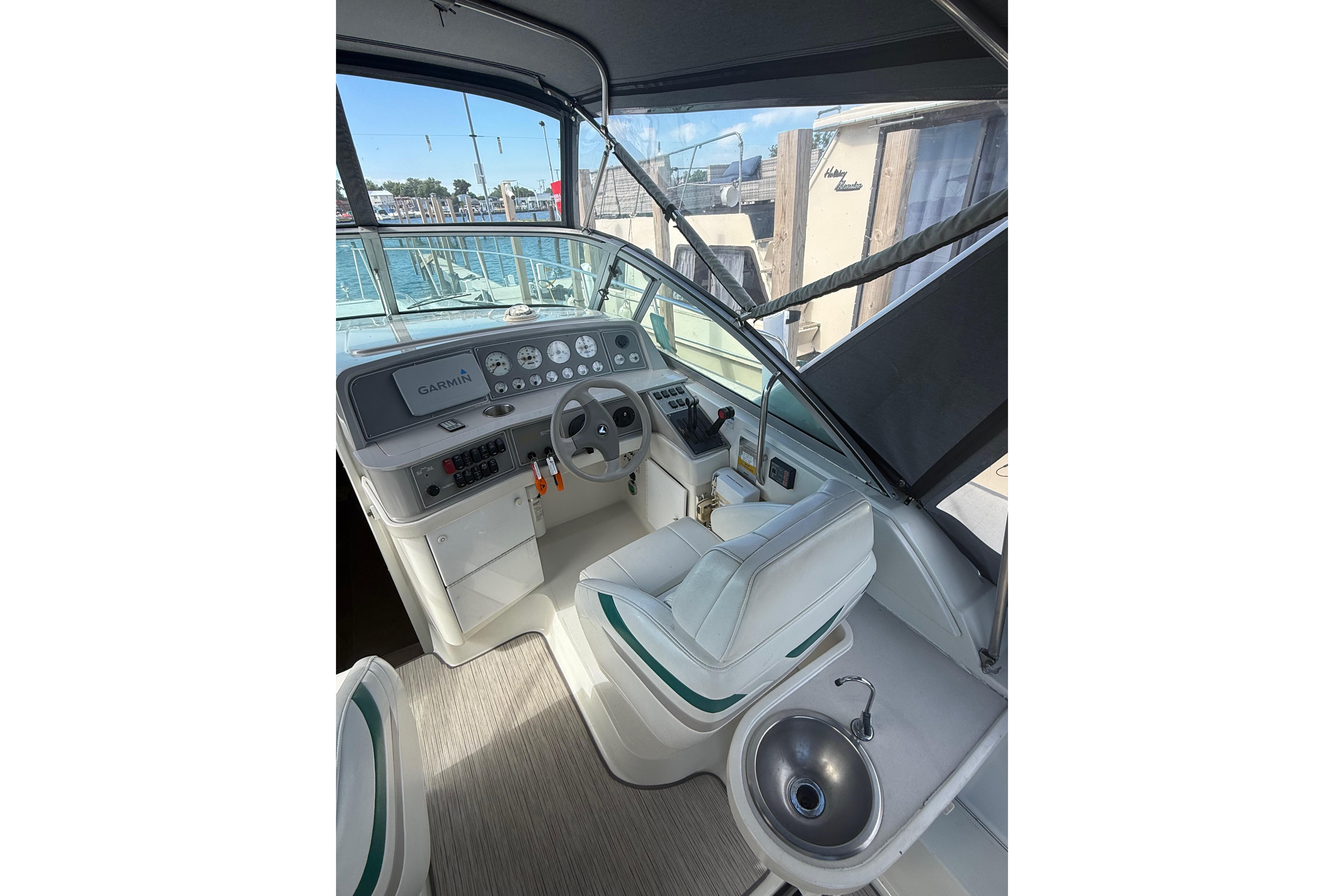 1999 Formula 34 Performance Cruiser helm with Garmin navigation, steering wheel, and sink.