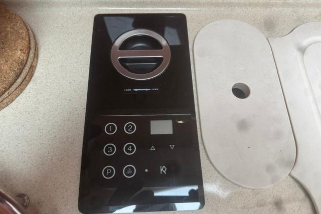 Control panel on a 1999 Sea Ray 420 Aft Cabin yacht, featuring buttons and a dial.