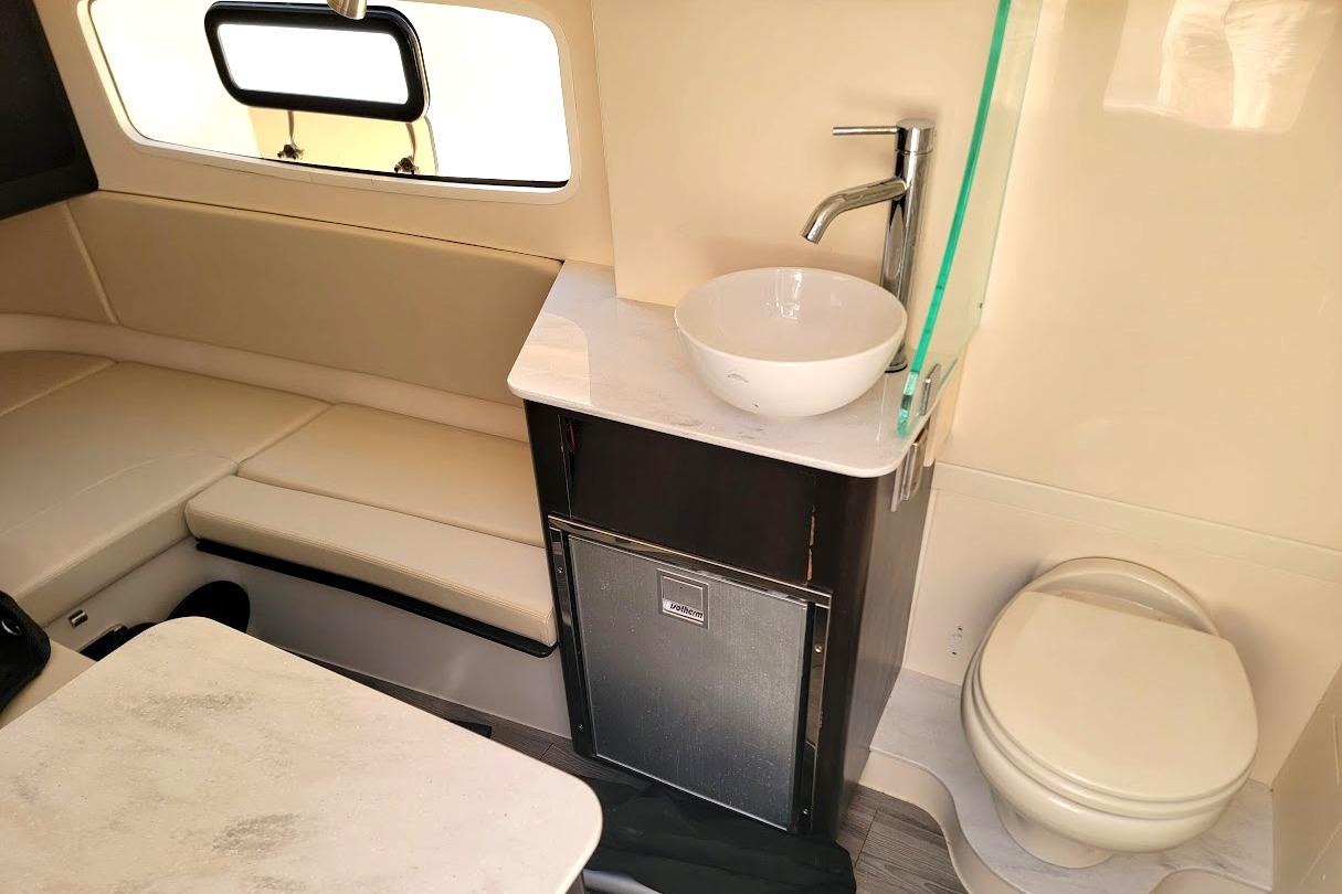 Luxurious interior of 2018 Scout 355 LXF boat with seating, sink, and toilet.